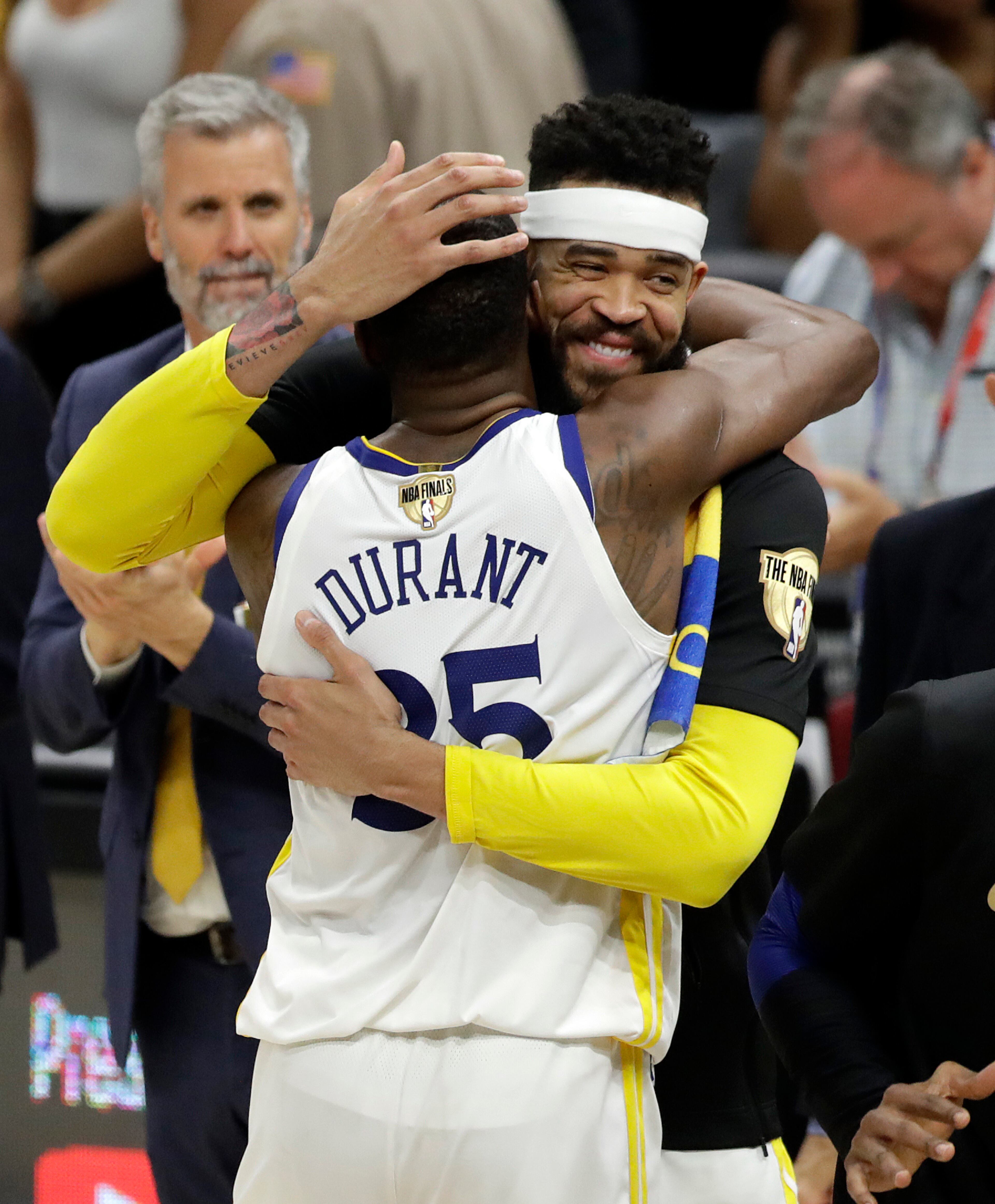 Golden State Warriors' Kevin Durant and JaVale McGee celebrate following Game 4 of basketball's NBA Finals against the Cleveland Cavaliers, Friday, June 8, 2018, in Cleveland. The Warriors defeated the Cavaliers 108-85. (AP Photo/Tony Dejak)