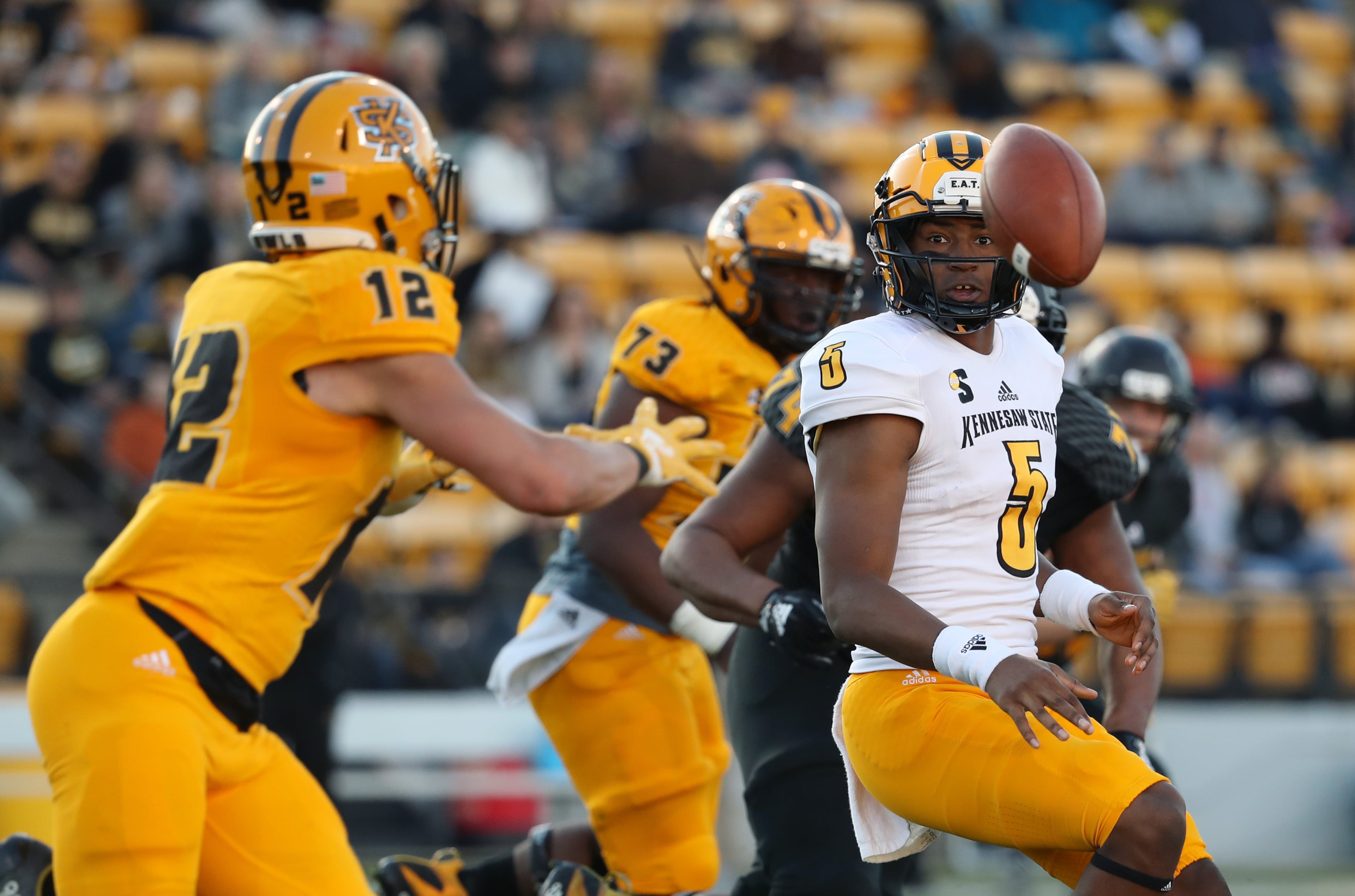 March 22, 2019 - Kennesaw, Ga: Kennesaw State Owls quarterback Tommy Bryant (5) pitches the ball to running back Isaac Foster (12) during the KSU spring football game at Fifth Third Bank Stadium Friday, March 22, 2019 in Kennesaw, Ga.. (JASON GETZ/SPECIAL TO THE AJC)