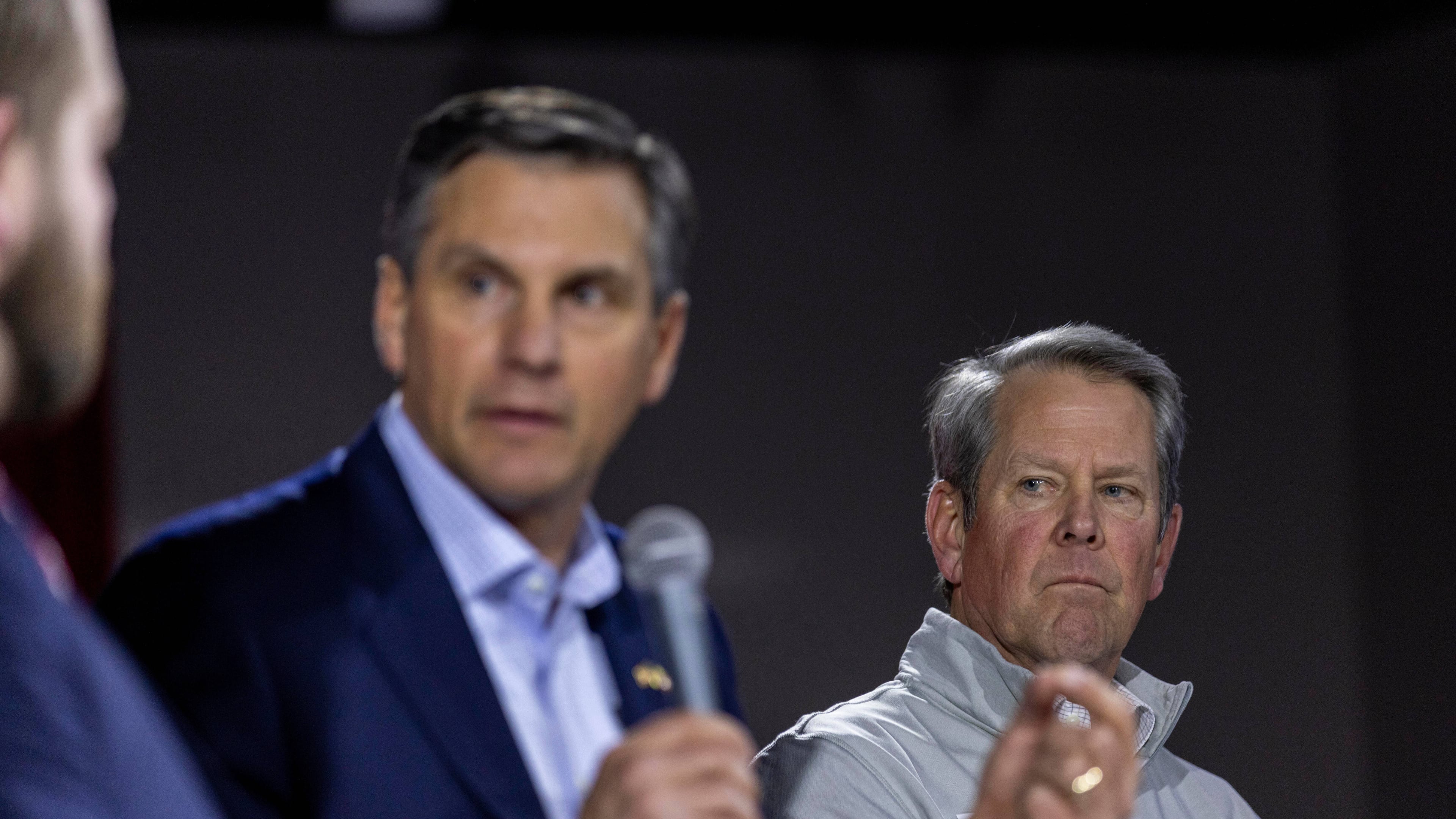 Georgia Gov. Brian Kemp, right, listens as Derek Dooley, left, a Republican candidate for Senate in Georgia, speaks during an Atlanta Young Republicans campaign event Thursday, Feb. 12, 2026, in Atlanta. (Alyssa Pointer/AP)