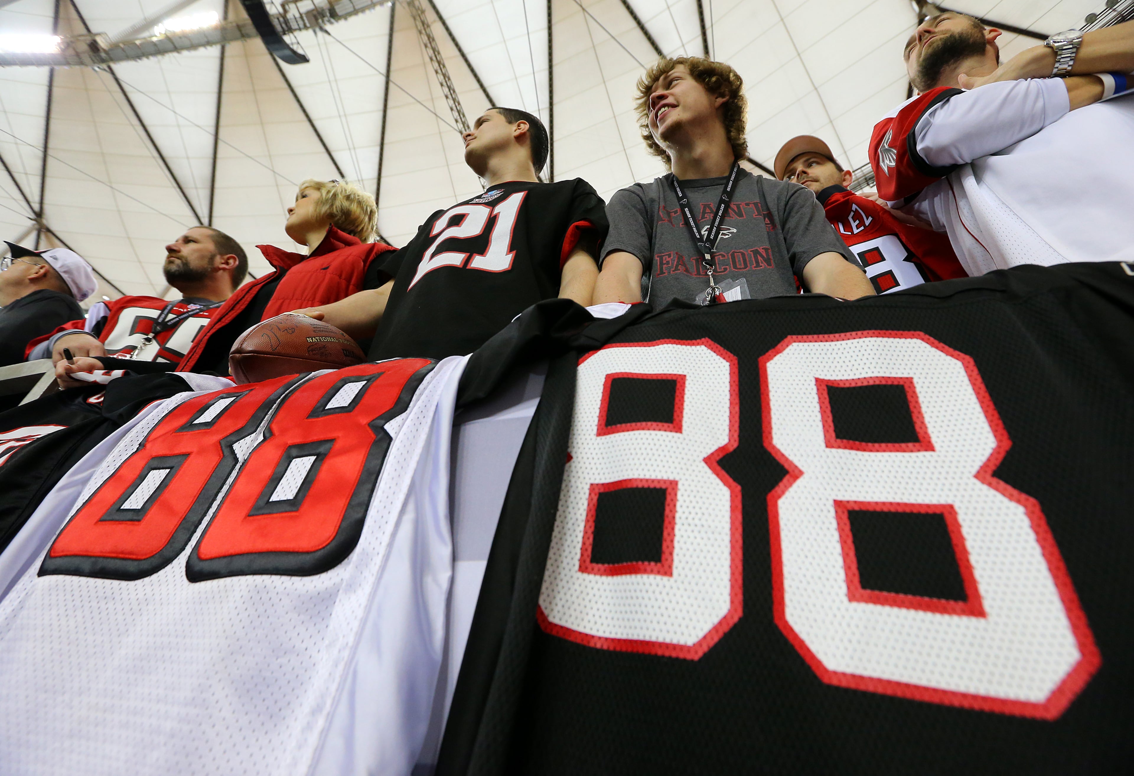 Mario Watkins (left), Gainesville, and Jace Cameron (right), Woodstock, have their #88 jerseys in front of them hoping for an autograph as Falcons tight end Tony Gonzalez prepares to play the final game of his 17-year NFL career on Sunday, Dec. 29, 2013, in Atlanta.
