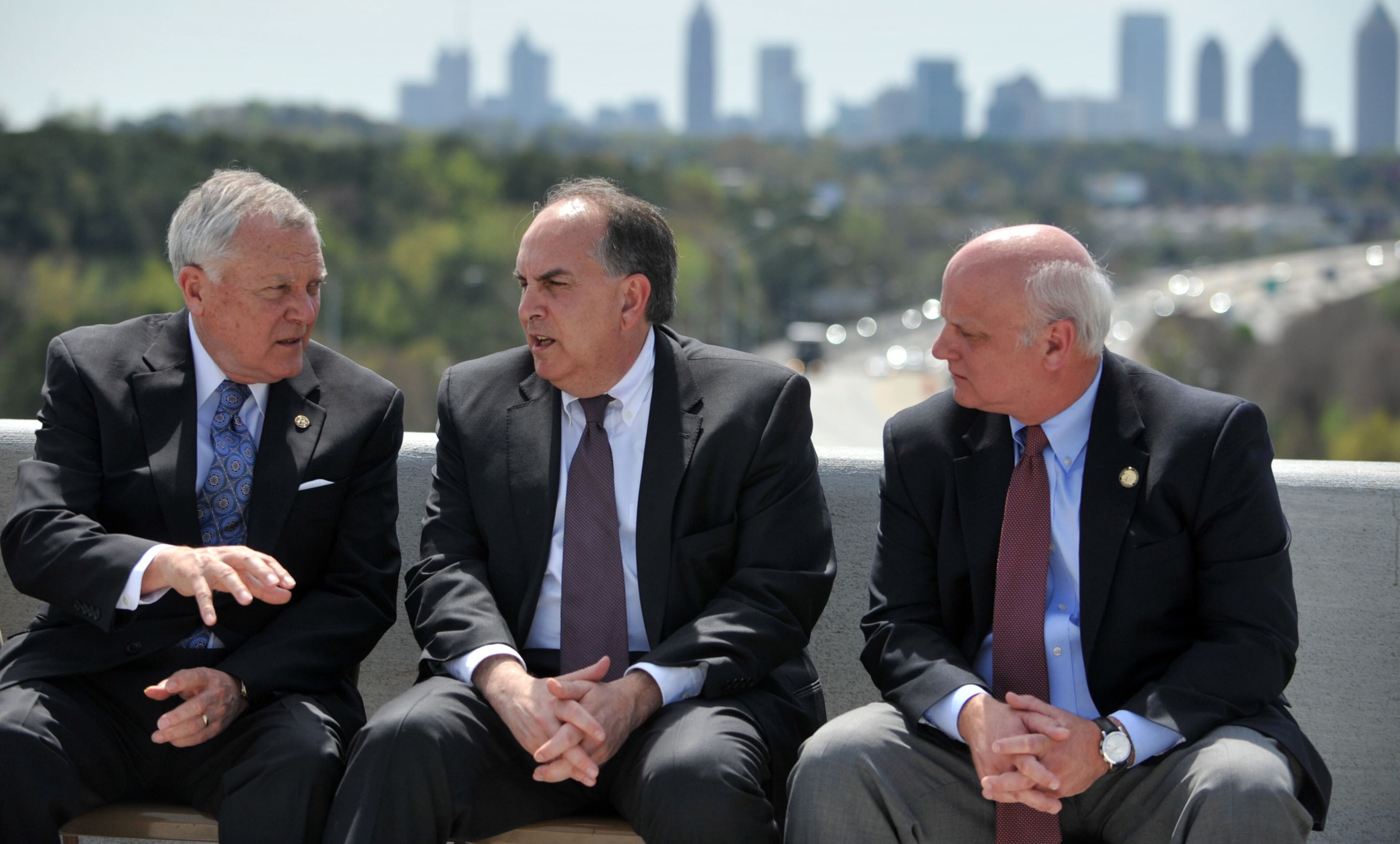 Governor Nathan Deal (from left) talks with State Rep Edward Lindsey and State Senator Brandon Beach before the program, Deal and other state and local leaders conducted a brief ribbon-cutting celebration of the opening of the new flyover ramps Wednesday, April 2, 2014. The ramps provide I-85 southbound traffic with direct access to GA 400 northbound and also give GA 400 southbound motorists a direct ramp to I-85 northbound.