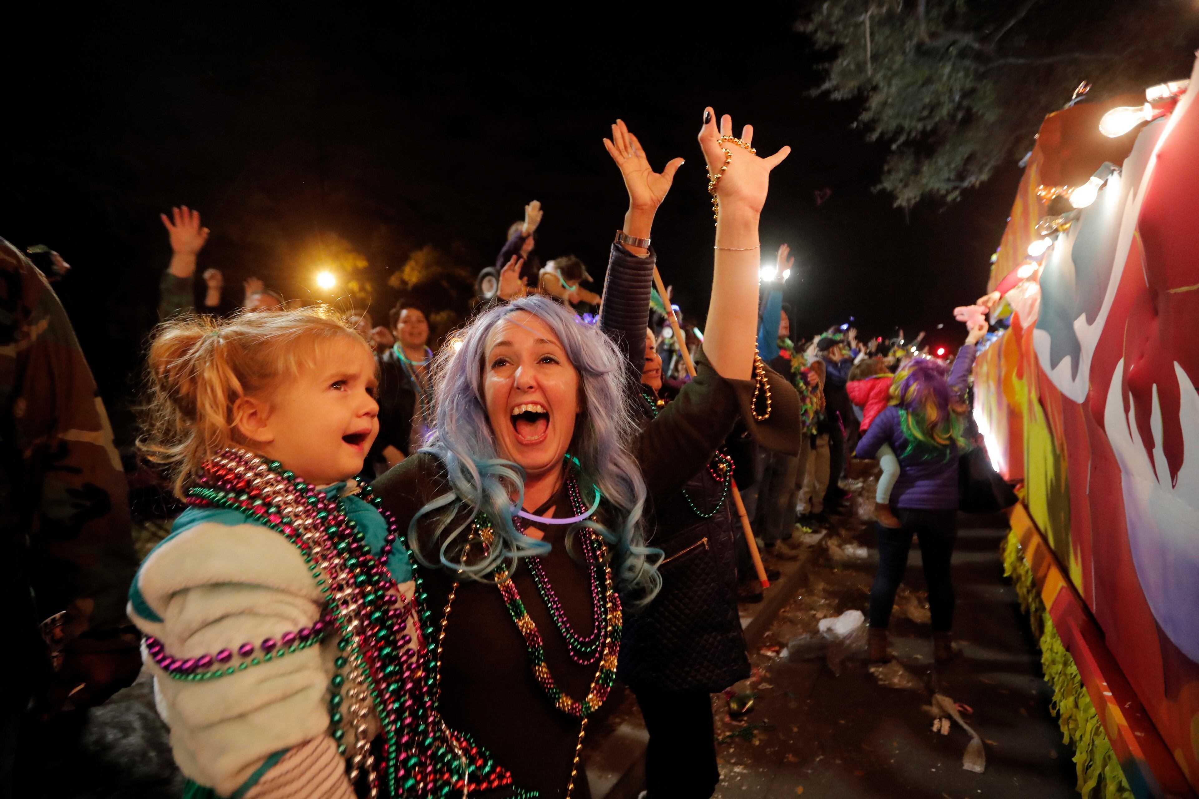 Revelers scream for trinkets at the Krewe of Cleopatra Mardi Gras parade in New Orleans, Friday, Feb. 2, 2018. Mardi Gras season is kicking into high gear with a slew of major parades throughout New Orleans. Although Carnival season officially began Jan. 6, the festivities really kick into high gear the two weekends ahead of Fat Tuesday. This year Fat Tuesday is Feb. 13. (AP Photo/Gerald Herbert)