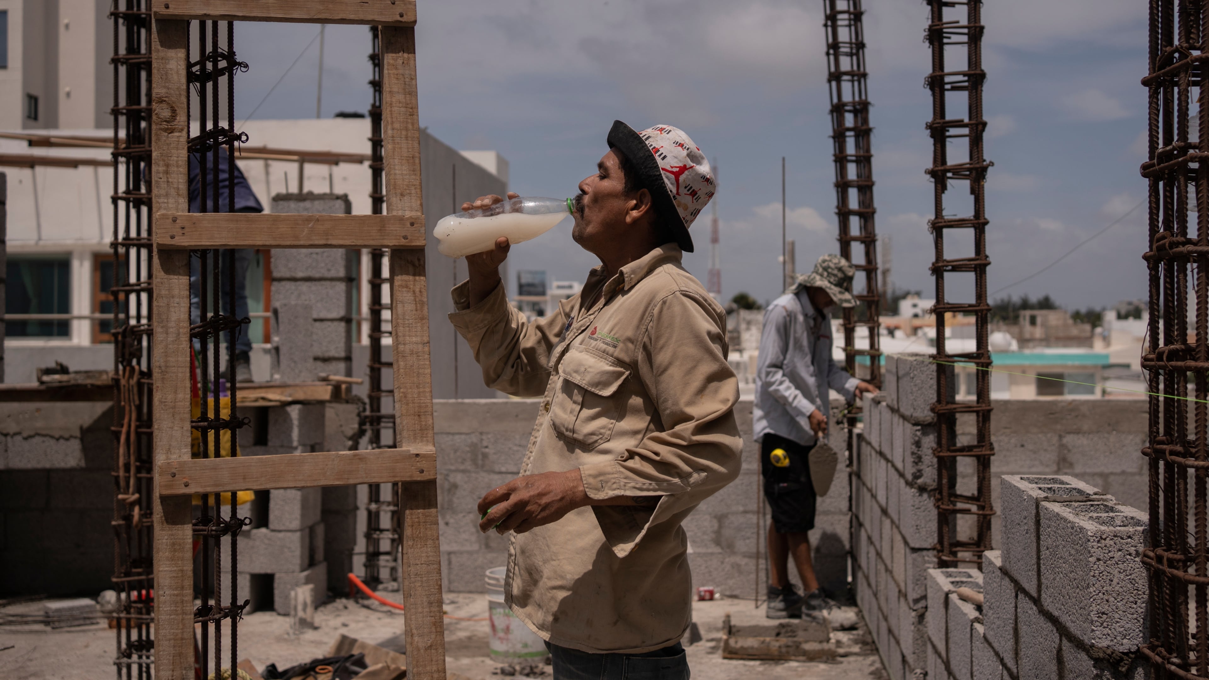FILE - Jorge Moreno, a worker, drinks flavored water to cope with the heat wave during his workday at a construction site in Veracruz, Mexico, on June 17, 2024. (AP Photo/Felix Marquez, File)
