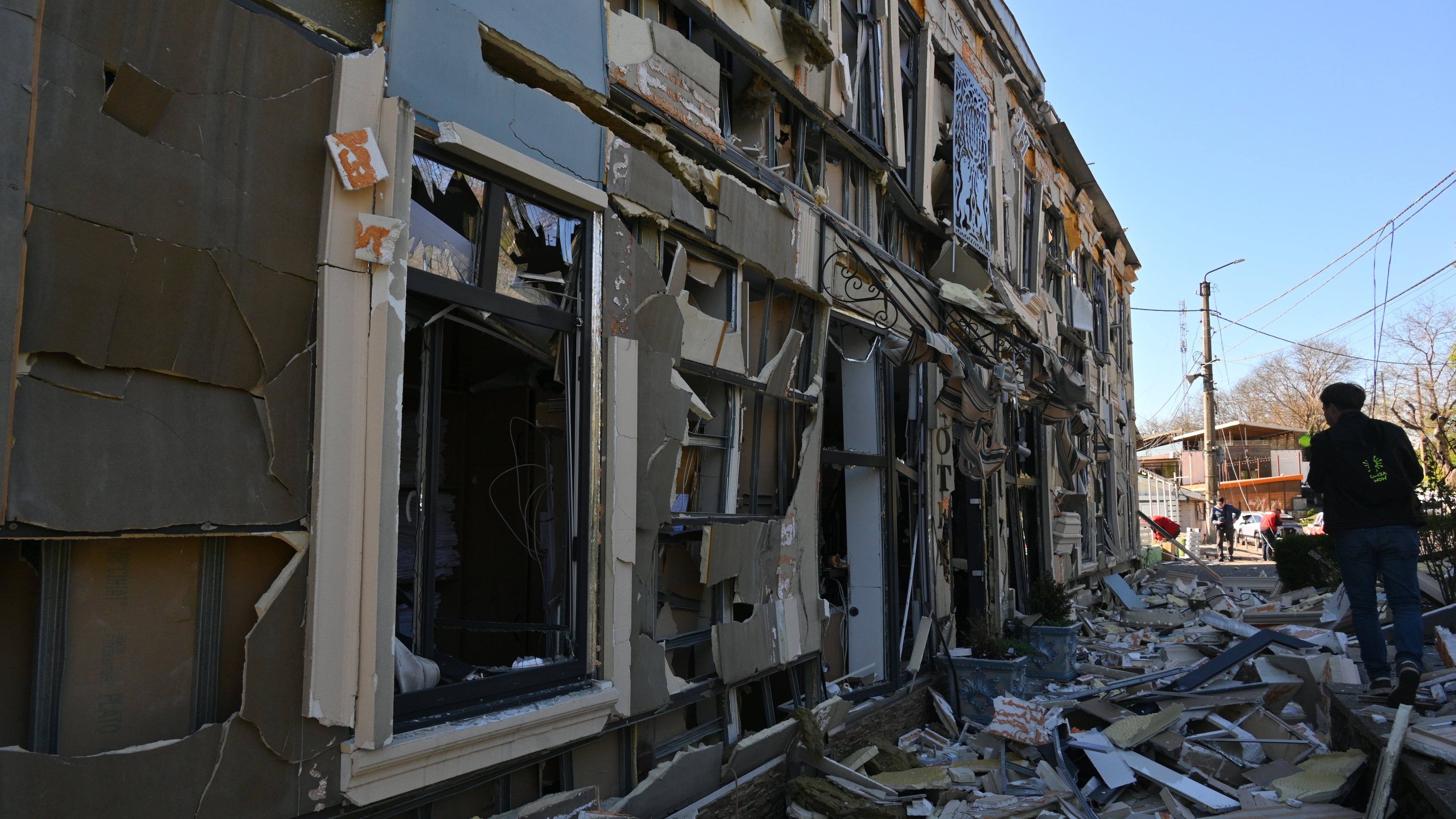 A person walks near residential houses damaged by a Russian strike in Odesa, Ukraine, Monday, April 27, 2026. (AP Photo/Michael Shtekel)
