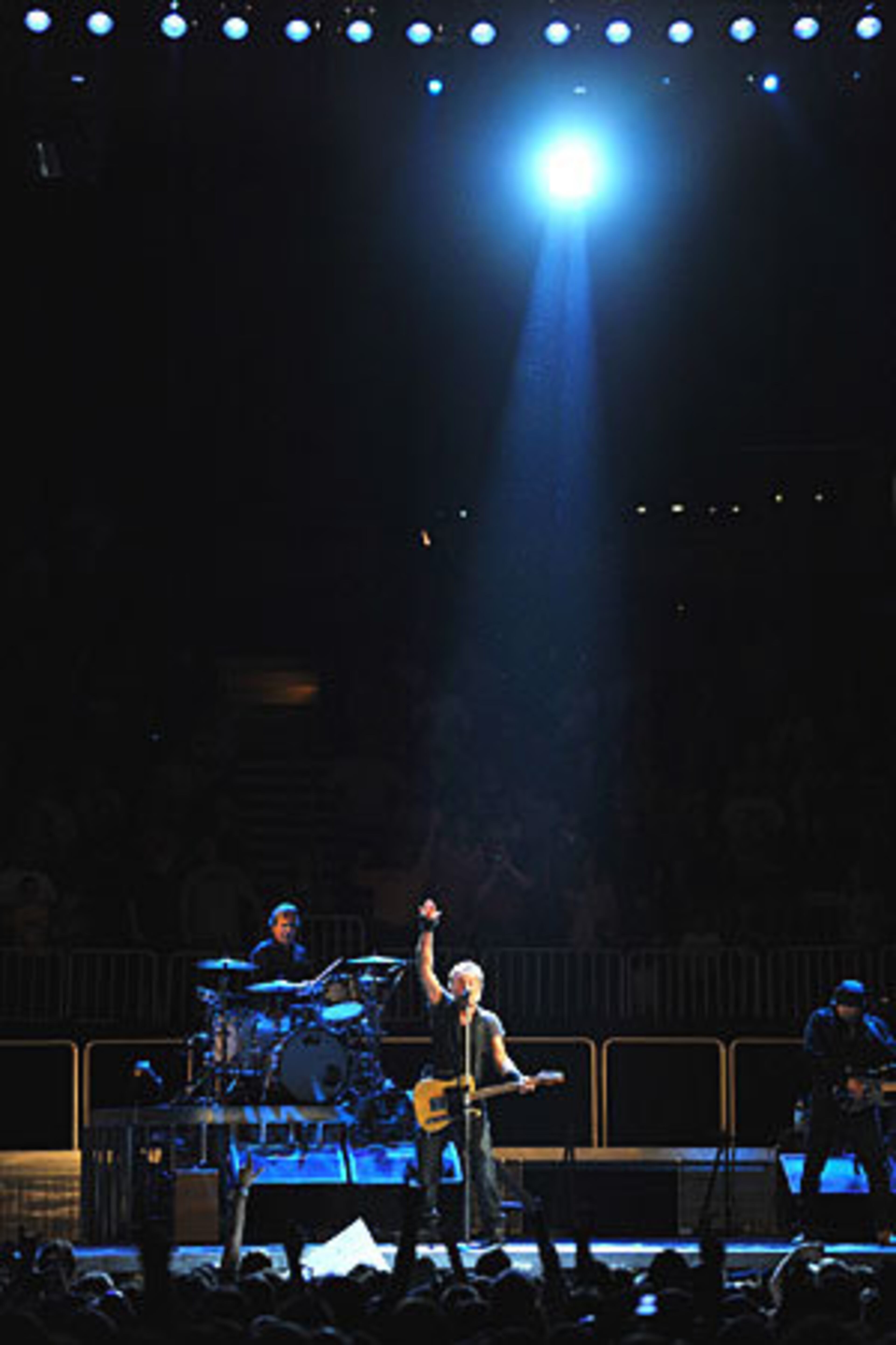 Springsteen sings "Darkness on the Edge of Town."