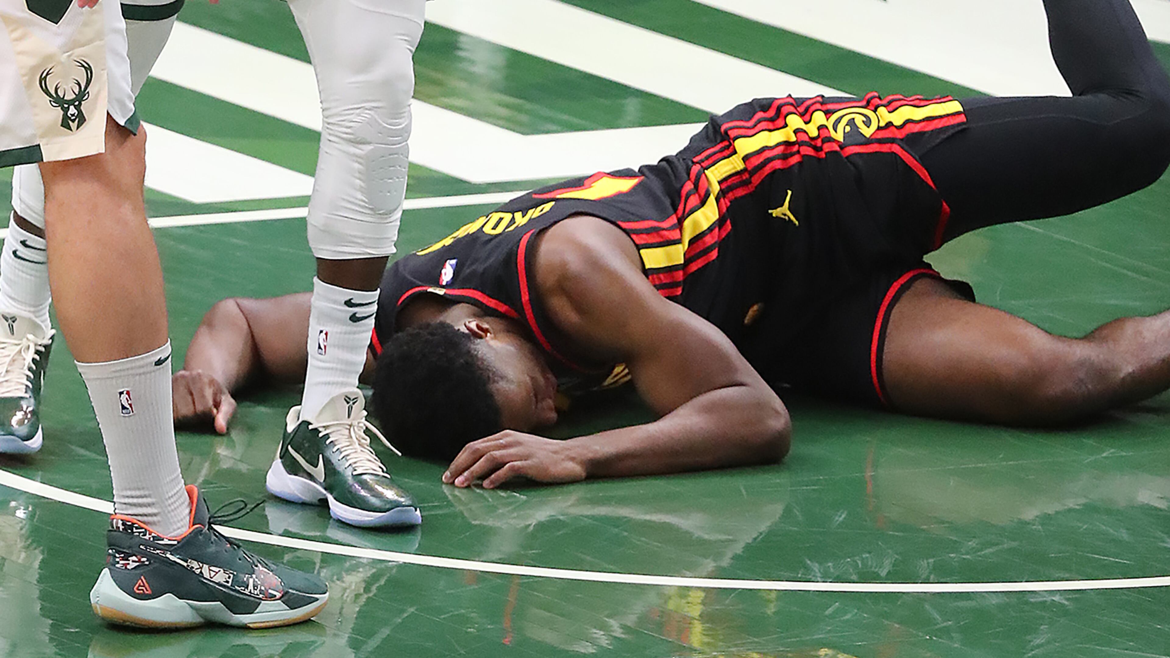 Hawks' Onyeka Okungwu is knocked to the hardwood with a hard foul. “Curtis Compton / Curtis.Compton@ajc.com”