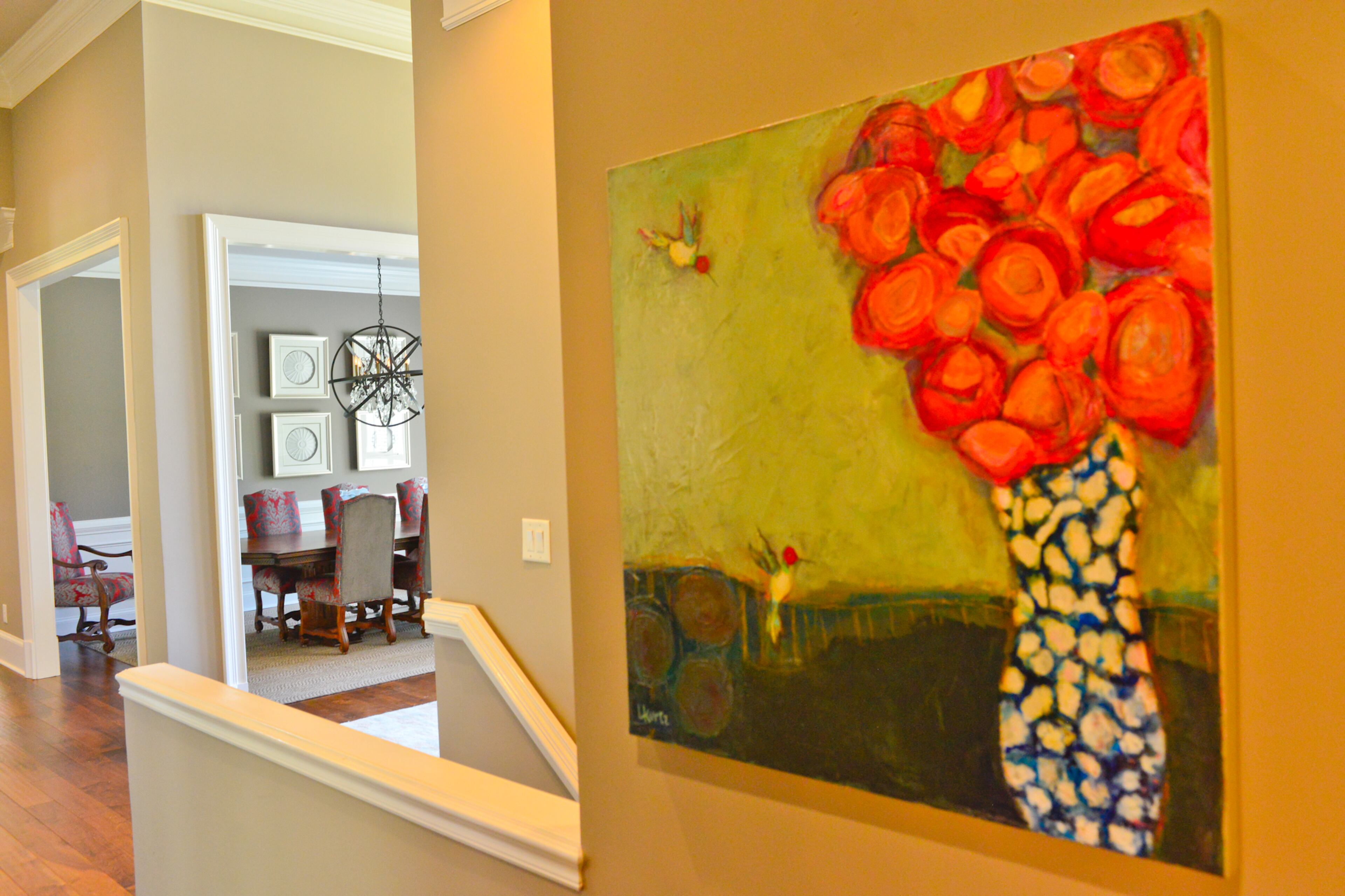Local artwork can be found throughout the Woodstock home. This vibrantly colored piece by Alpharetta artist Lorra Kurtz, titled “Come go with me,” hangs in the foyer.