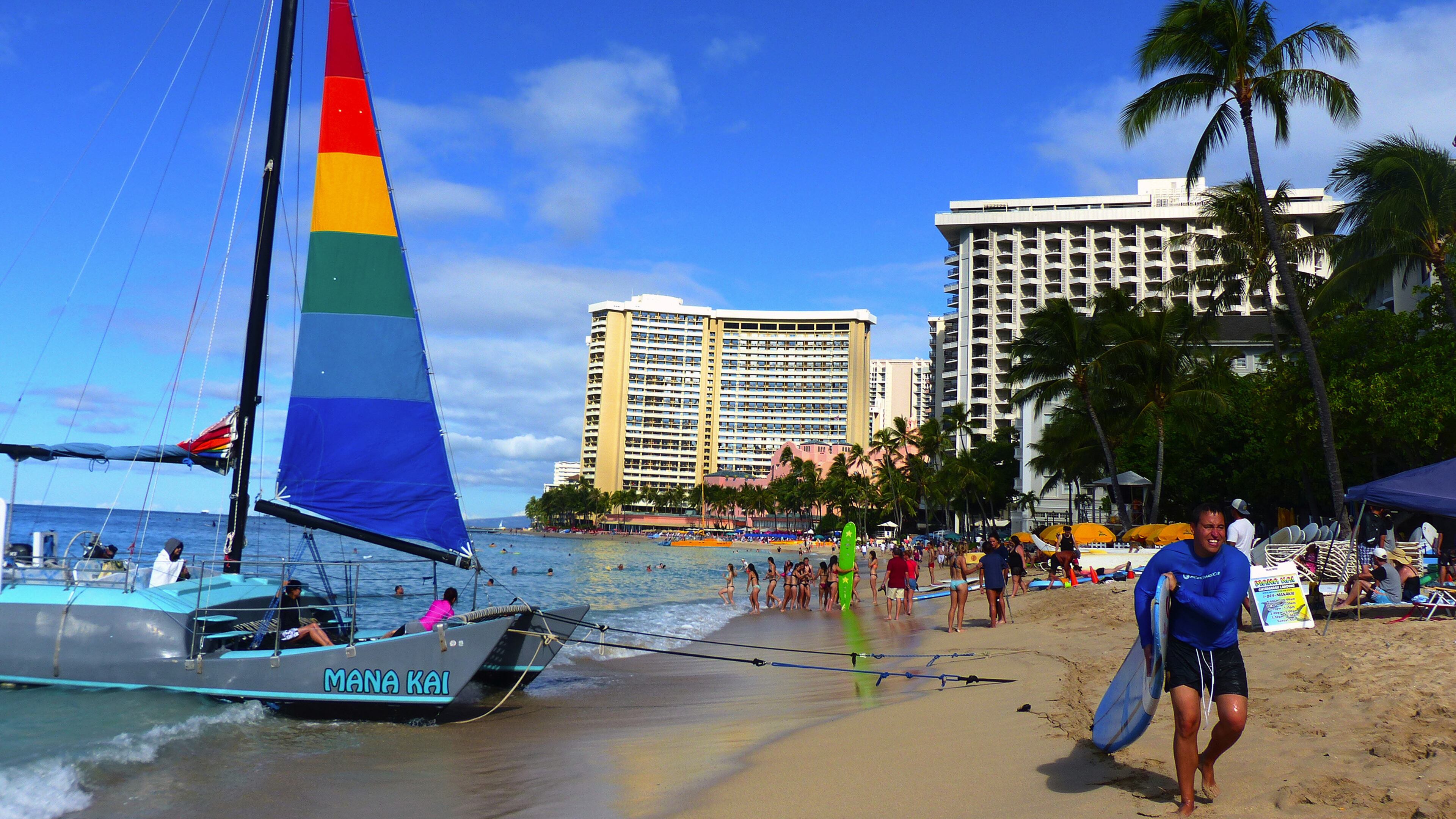 Surfers and a sailboat crowd popular Waikiki Beach, where there's plenty to do for visitors of all ages. (Brian J. Cantwell/The Seattle Times/TNS)