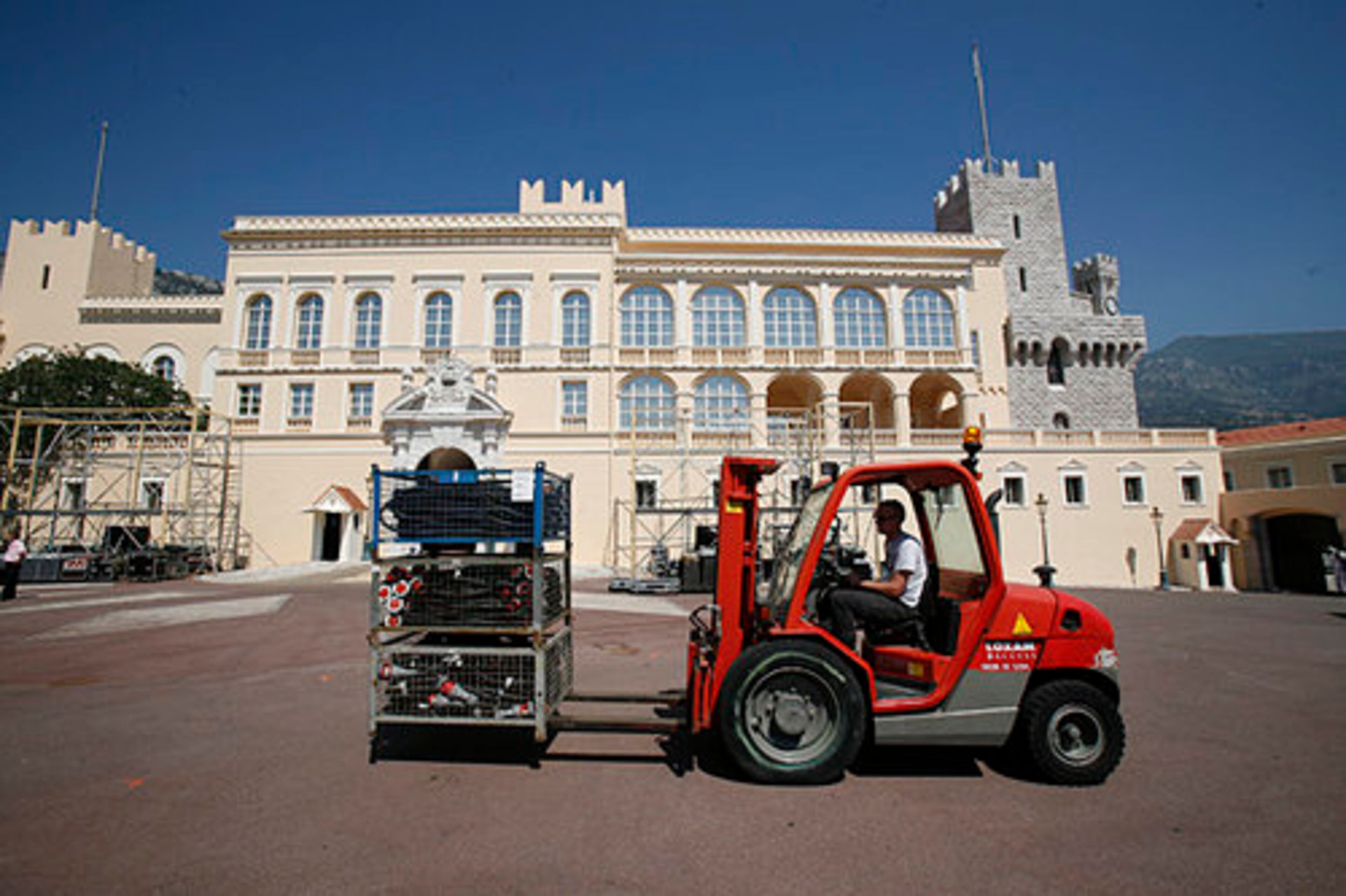 Workers prepare in front of the palace.