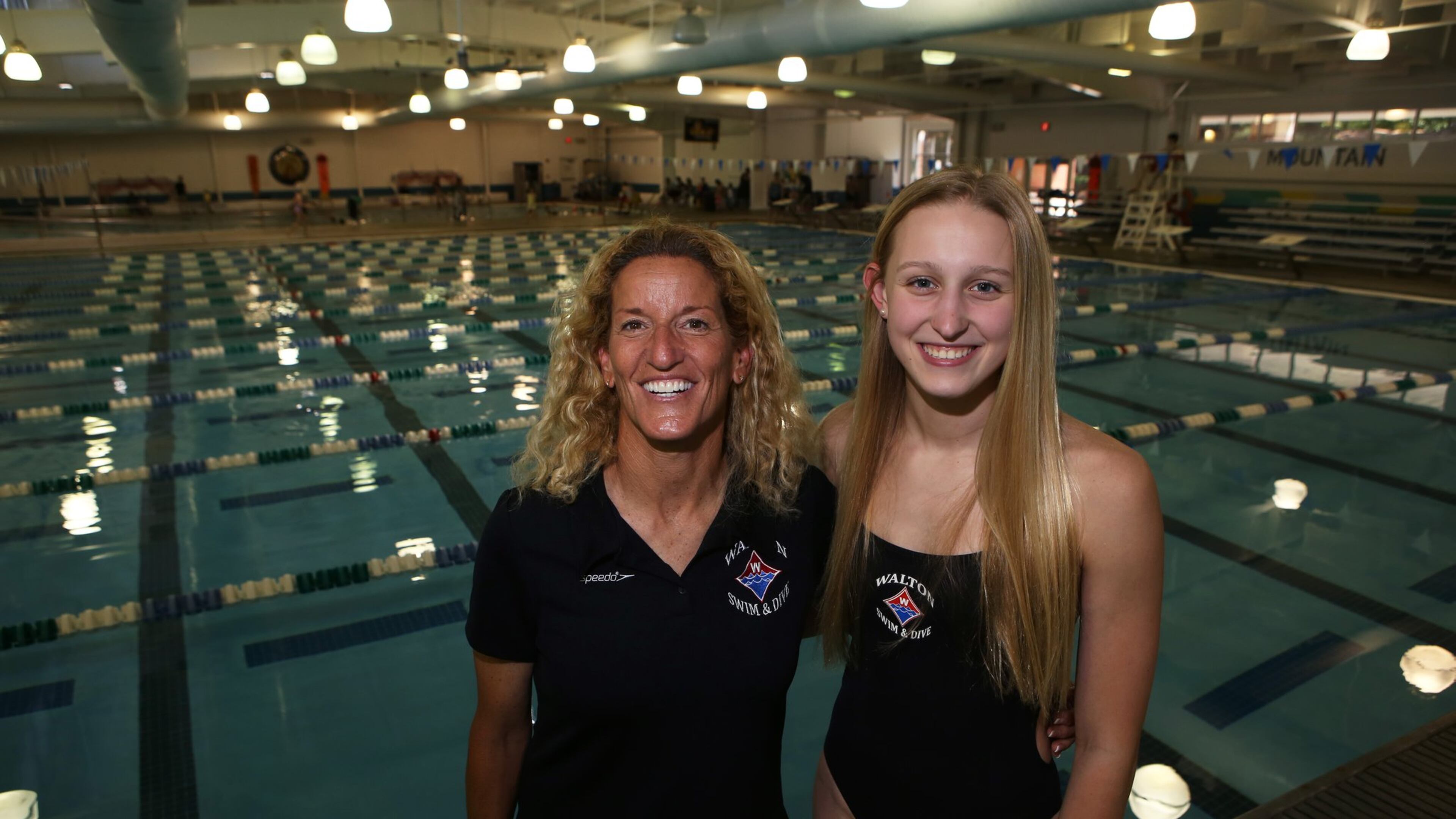 Emma Cole (right) and her head coach Sharon Loughran at the Mountain View Aquatic Center in Marietta on May 10, 2017. In addition to her swim team taking first place in the 400m freestyle relay at the state championships, beating their previous record, Cole won first in both the 100 free and 200 free. She will attend the University of North Carolina in the fall after swimming year-round since she was 8 years old. (Henry Taylor / Henry.Taylor@AJC.com)