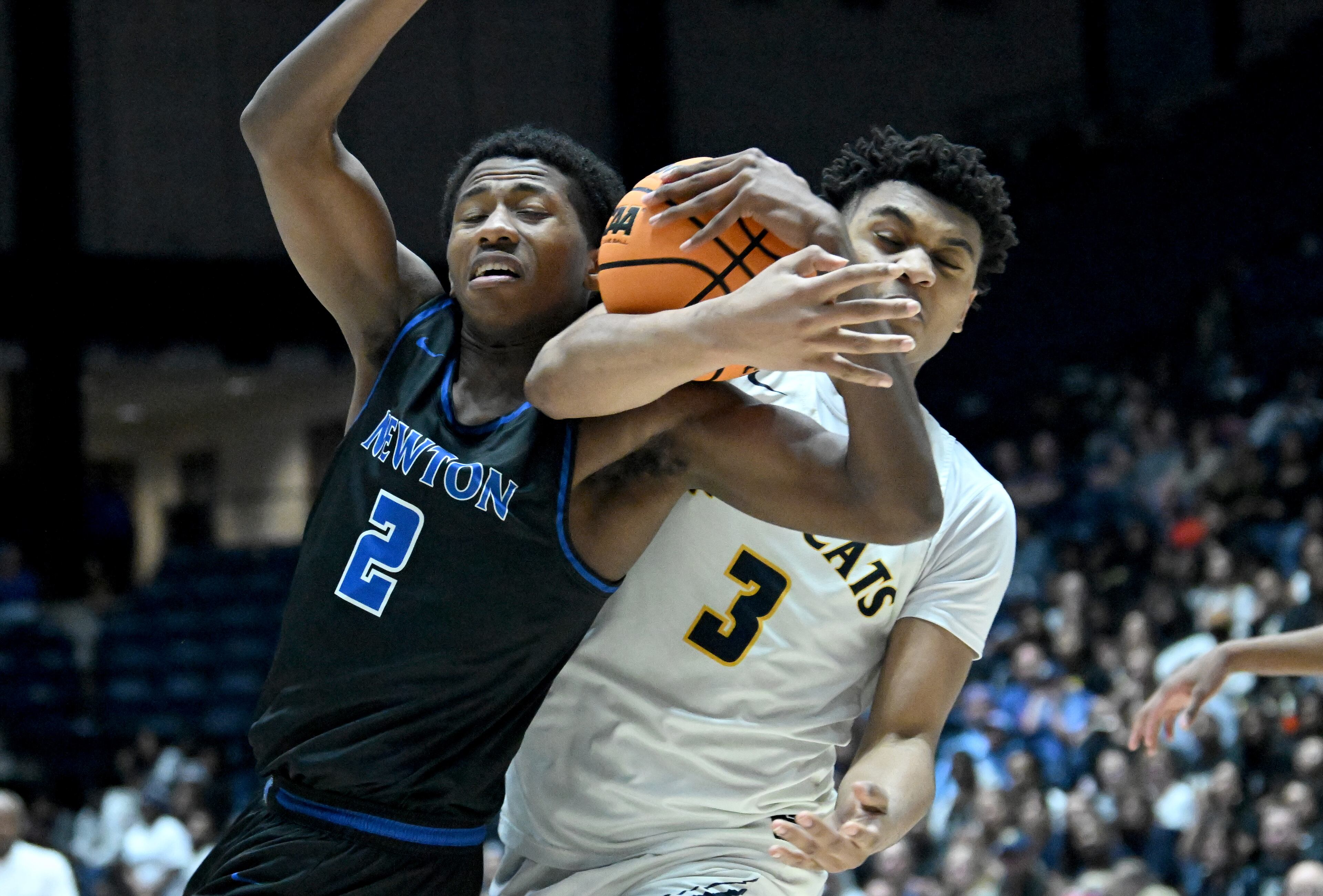 Newton's Davin Neal (2) collides with Wheeler's Colben Landrew (3) as they fight for a rebound during the second half of the GHSA Boys 6A State Championship at the Macon Centreplex, Saturday, March 8, 2025, in Macon. Wheeler won 61-56 over Newton. (Hyosub Shin / AJC)
