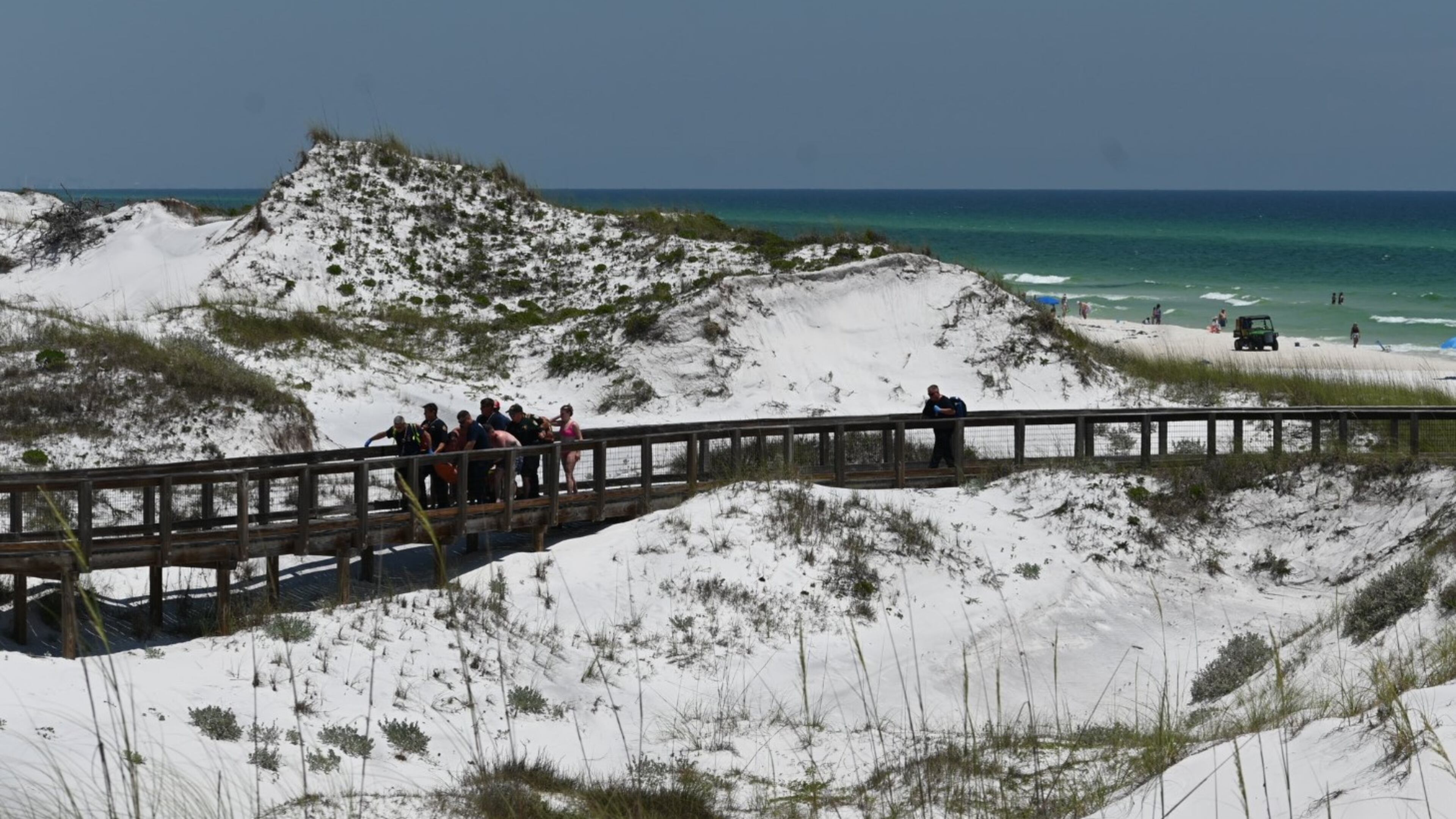 A photo from the Walton County Sheriff's Office shows first responders carrying a Florida Panhandle shark attack victim up the boardwalk on Friday, June 7, 2024.