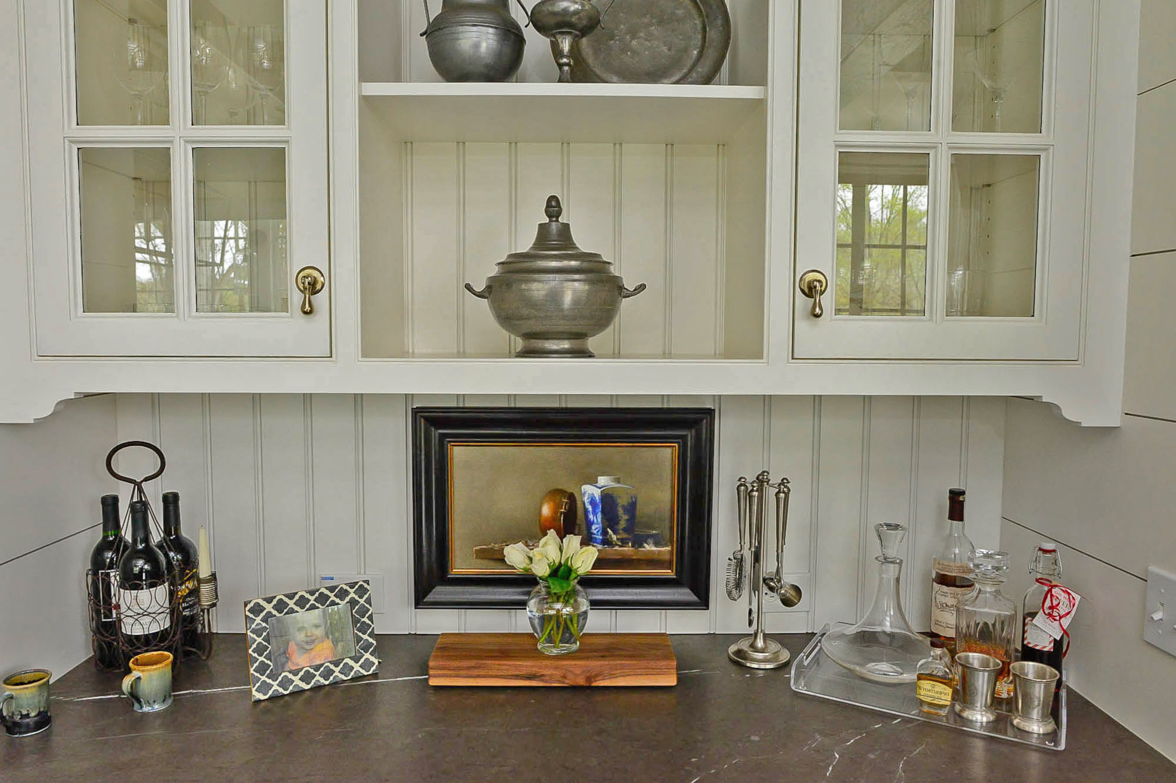 A collection of pewter in a bar niche adds a handsome element to the design aesthetic, said homeowner Ellen Turner. The bar also has the graphite limestone used for the countertops and backsplash in the kitchen. Christopher Oquendo/AJC FILE