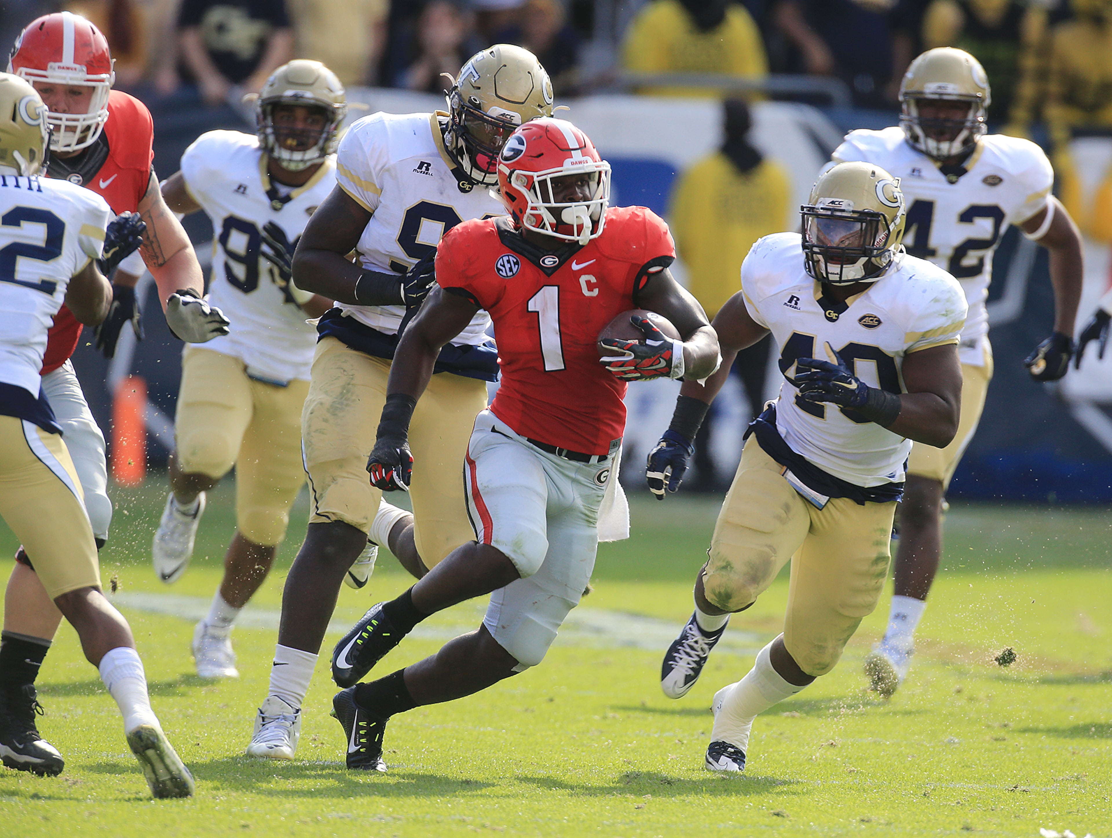 Georgia tailback Sony Michel cuts through Georgia Tech defenders for a long gain during the second half in a football game on Saturday, Nov. 28, 2015, in Atlanta. Michel led Georgia with 24 carries for 149 yards on a touchdown on the way to a 13-7 victory. Curtis Compton / ccompton@ajc.com