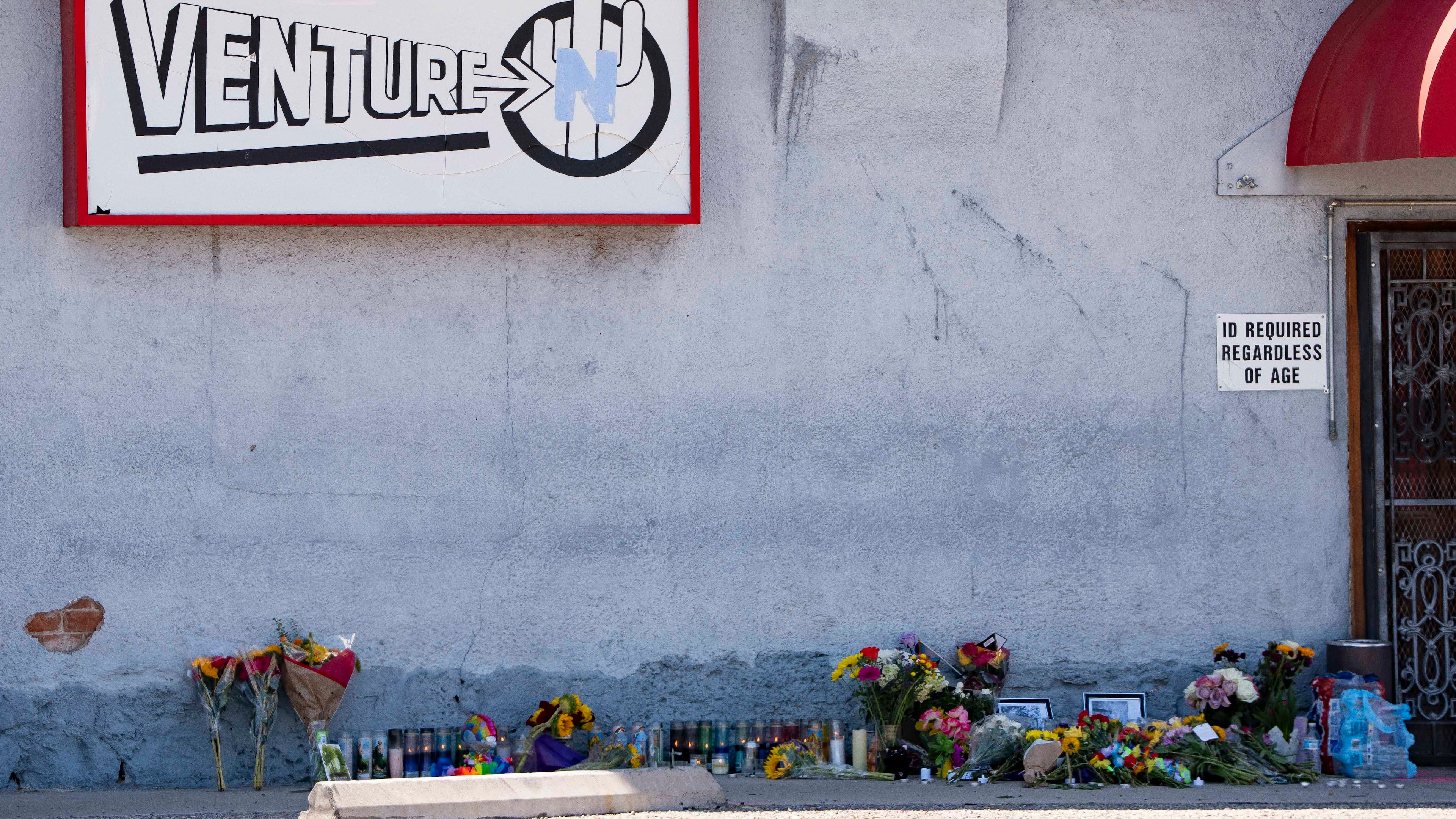 A growing memorial sits outside the Venture-N Bar in Tucson, Ariz., Tuesday, Sept. 1, 2026, for Vincent Siquieros and Cameron Capara, who were fatally shot in the parking lot of the gay bar shortly after midnight Monday. (AP Photo/Rebecca Noble)