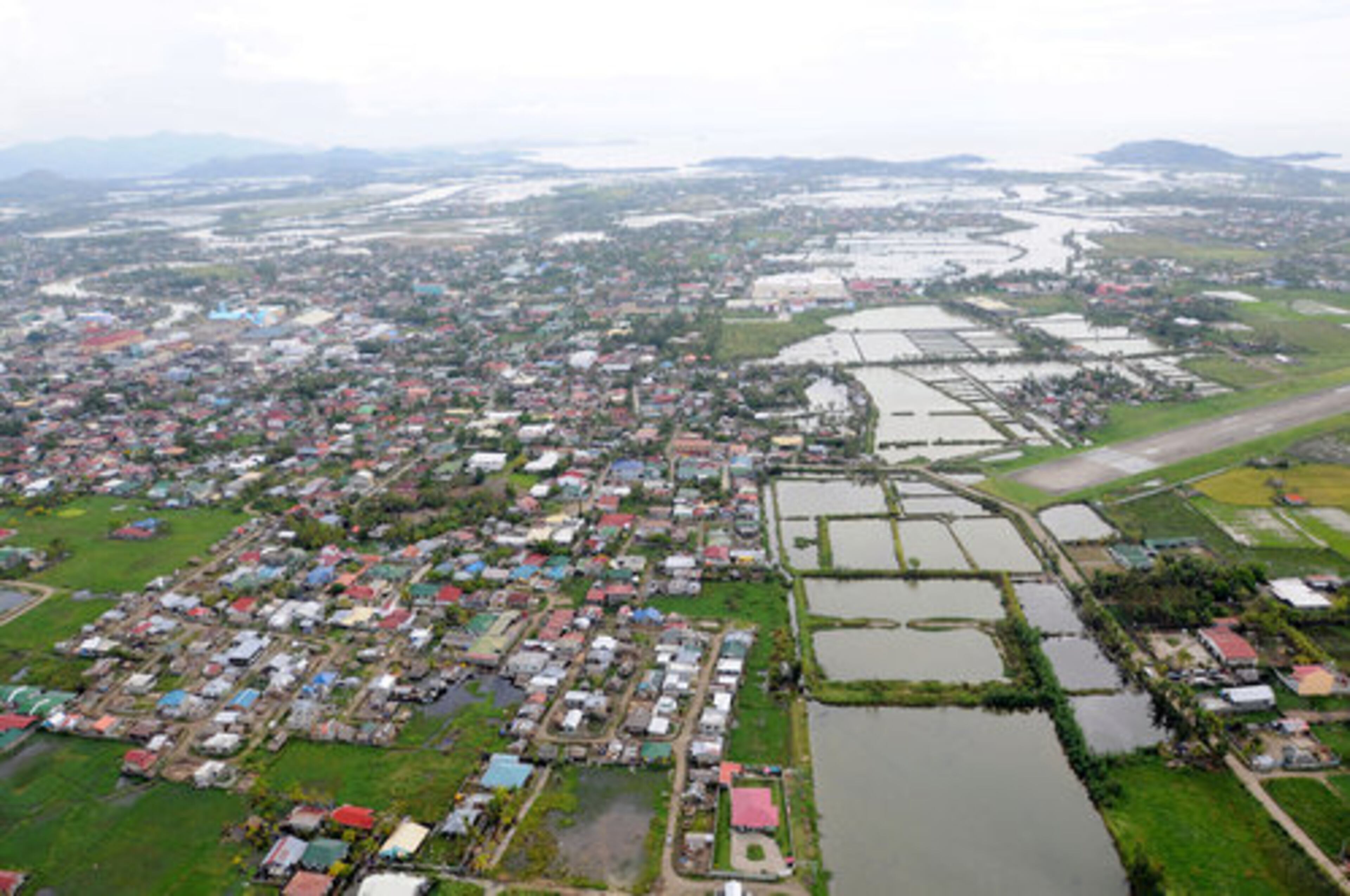 This handout photograph shows an aerial view of flooded fields and standing water after Typhoon Fengshen in Roxas, Philippines, on Thursday. At the request of the Filipino government, the aircraft carrier U.S.S. Ronald Reagan is off the coast of Panay Island to provide humanitarian assistance and disaster response.
