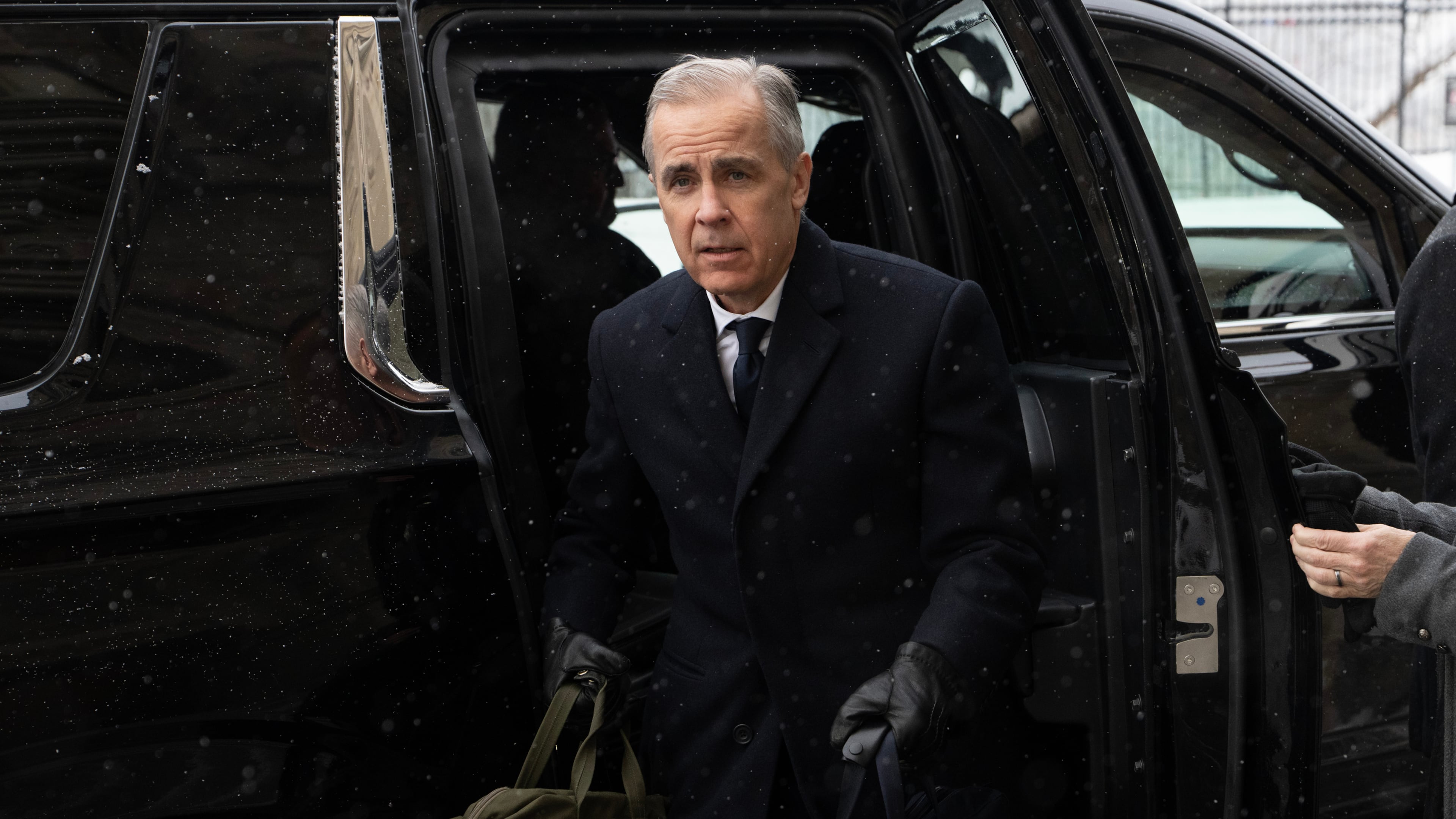 Canadian Prime Minister Mark Carney arrives by motorcade to Parliament Hill in Ottawa, Tuesday, Jan. 27, 2026. (Adrian Wyld/The Canadian Press via AP)