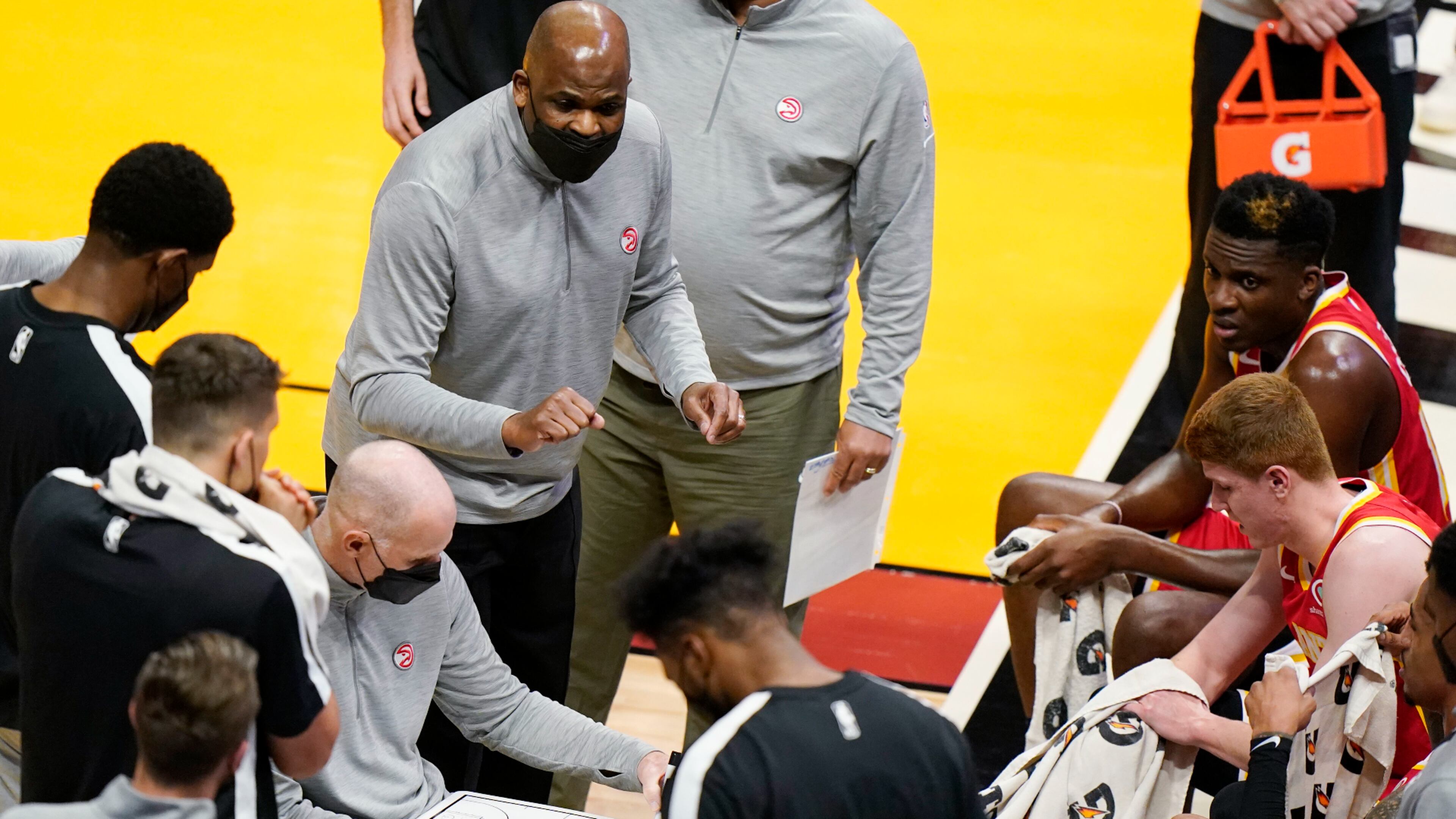 Atlanta Hawks interim coach Nate McMillan, center, gestures as he talks to players during a timeout in the first half of the team's NBA basketball game against the Miami Heat, Tuesday, March 2, 2021, in Miami. His opportunity to return to a head coach position comes with mixed feelings following Monday's firing of his friend, Lloyd Pierce. (AP Photo/Wilfredo Lee)