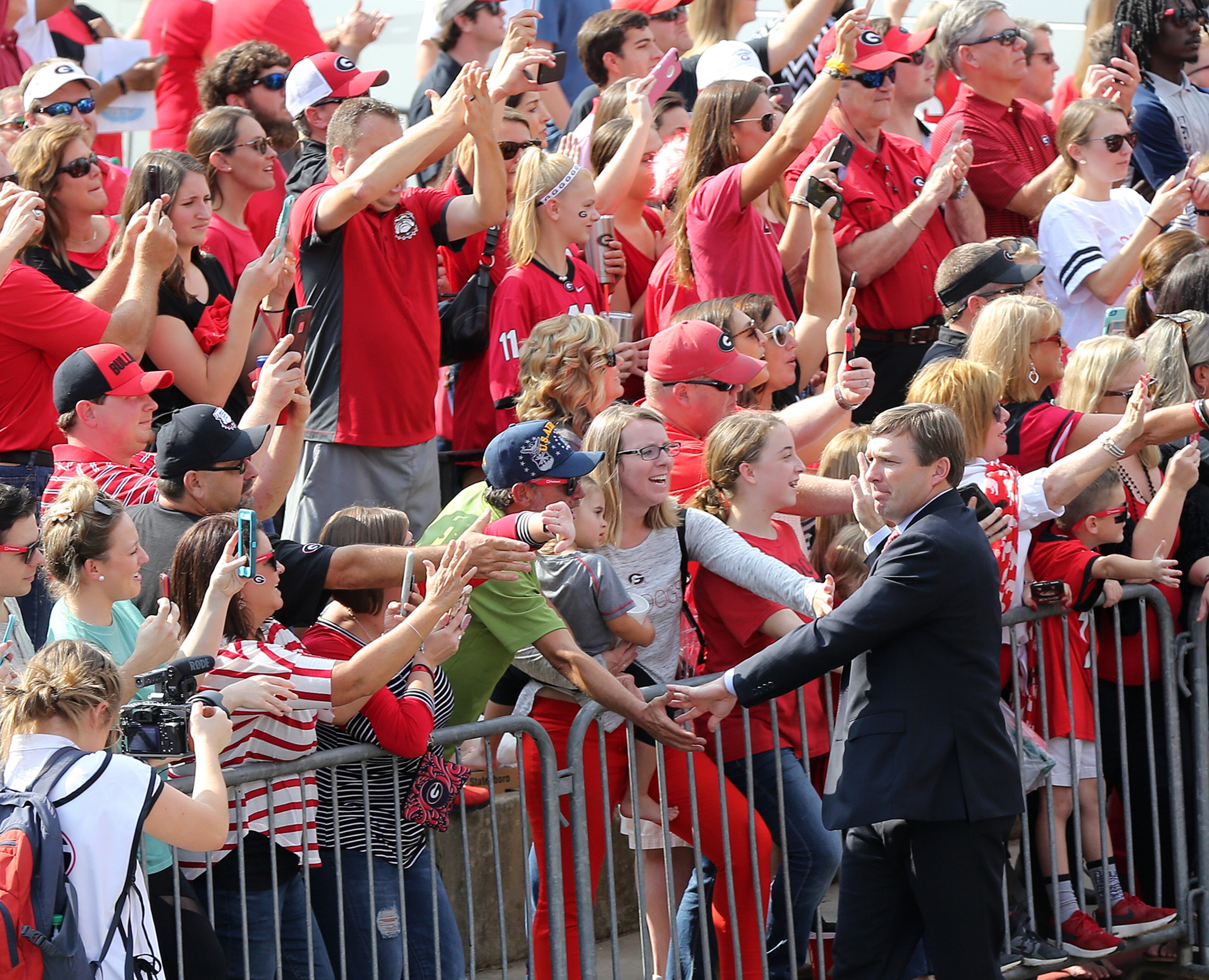 November 4, 2017 Athens: Georgia head coach Kirby Smart high fives fans during the team Dawg Walk into Sanford Stadium to play South Carolina in a NCAA college football game on Saturday, November 4, 2017, in Athens. Curtis Compton/ccompton@ajc.com