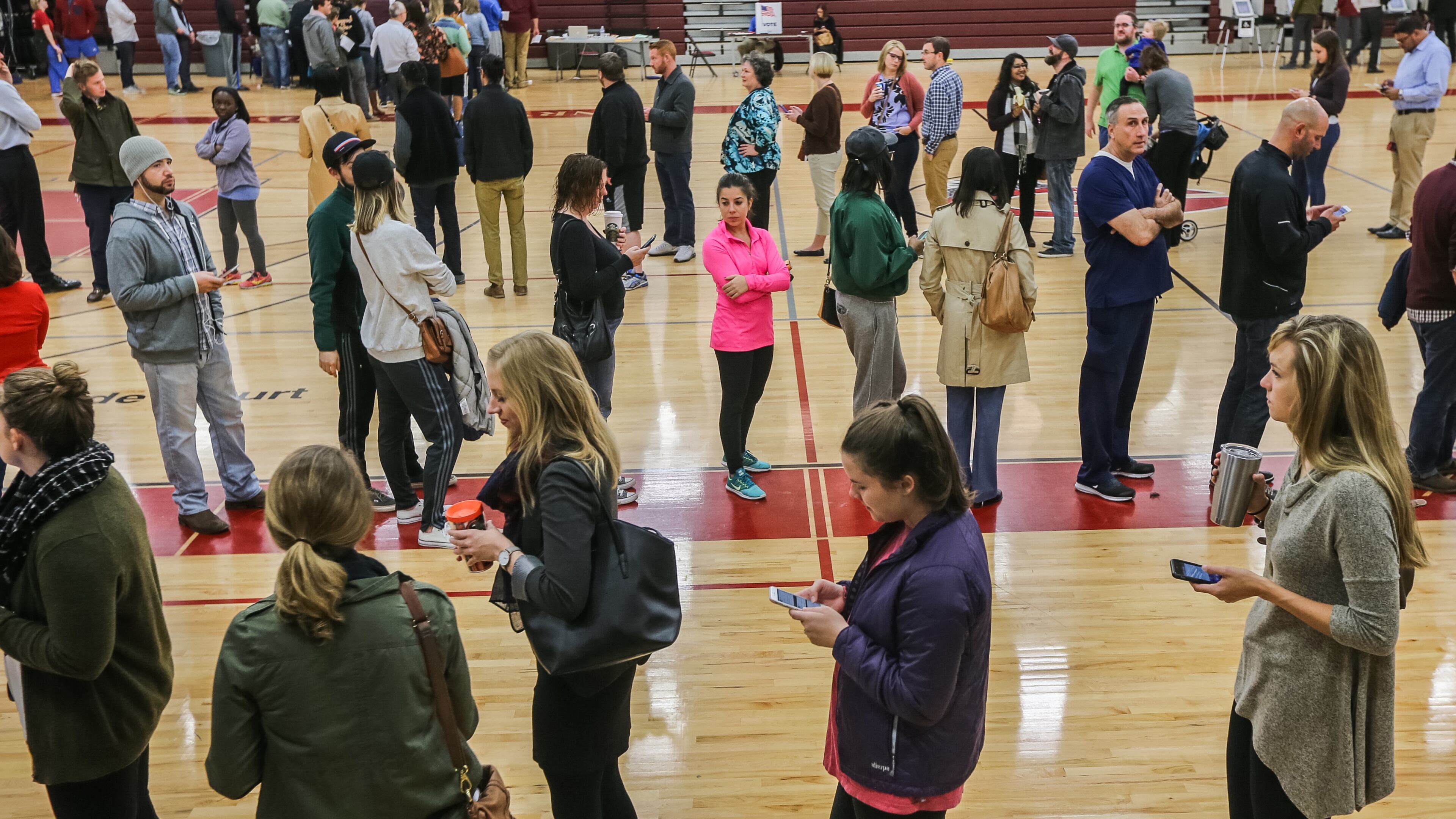 A triple line of voters at the Grady High School gymnasium in Atlanta as they wait to cast their votes on Tuesday morning, November 8 2016. JOHN SPINK / AJC