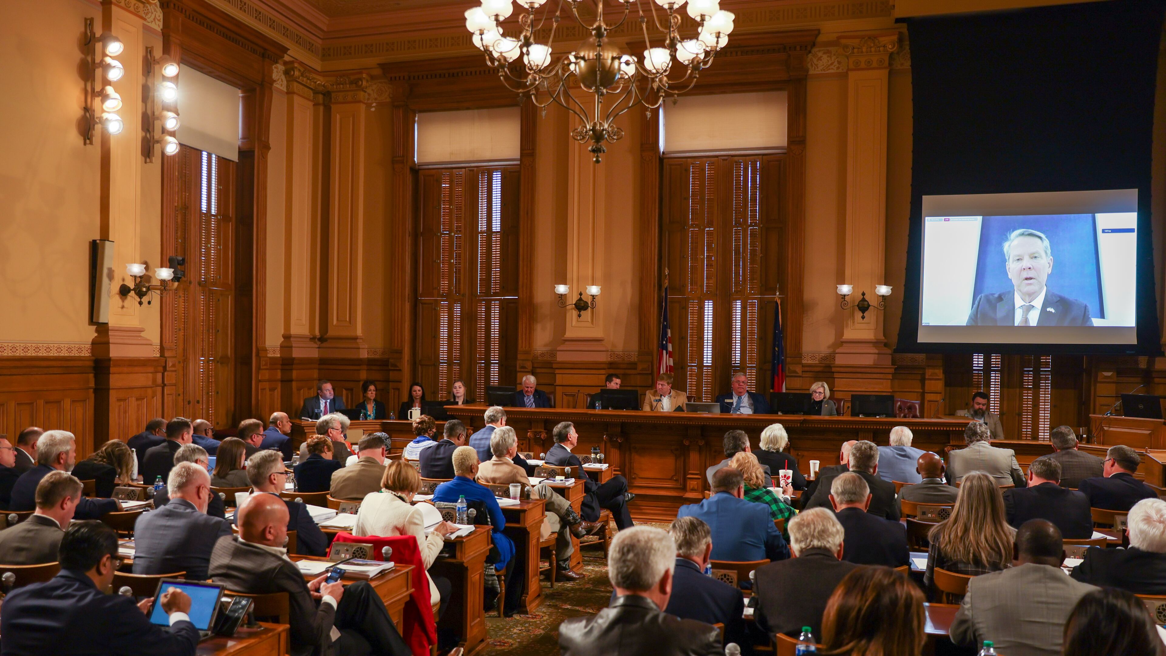 Members of the legislature listen to Gov. Brian Kemp (on screen) at the start on budget hearings in Atlanta on Tuesday, January 17, 2023. (Arvin Temkar/The Atlanta Journal-Constitution)