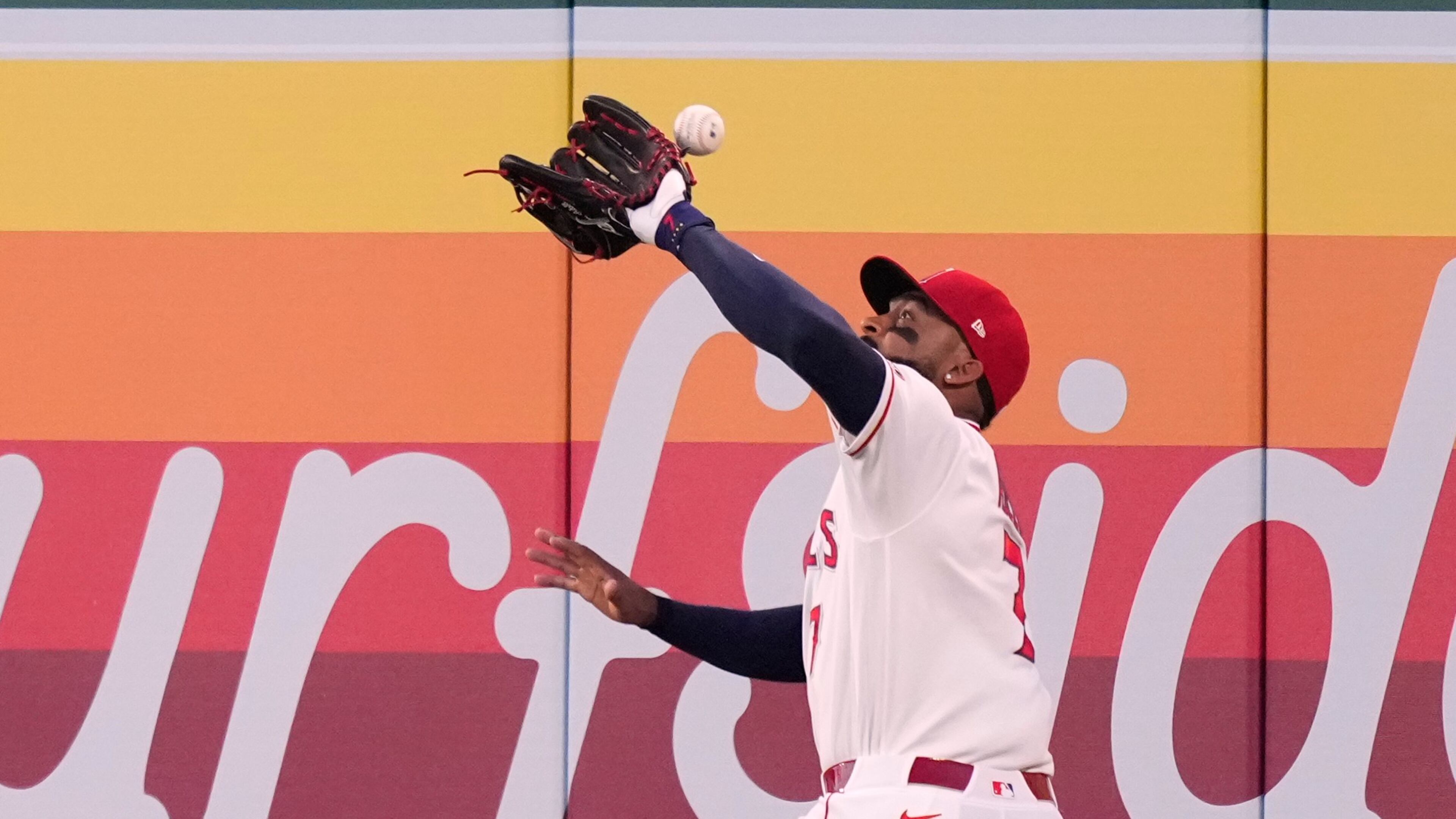 Los Angeles Angels right fielder Jo Adell misplays a ball hit by Colorado Rockies' TJ Rumfield that hit him in the head and then bounced out for a solo home run during the fourth inning of a baseball game Tuesday, June 2, 2026, in Anaheim, Calif. (AP Photo/Mark J. Terrill)