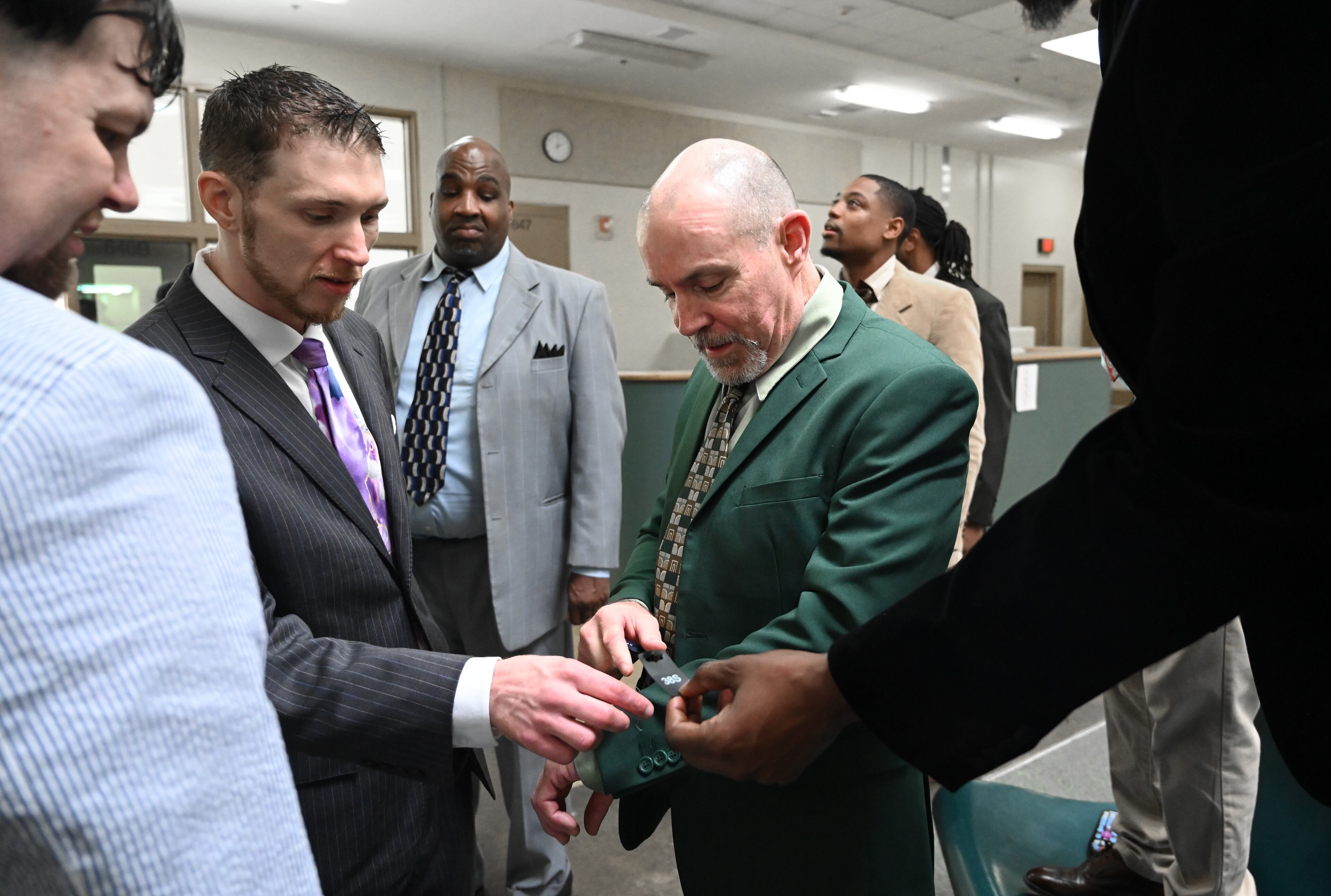 Kirby Kesler (center) talks with other program graduates as they prepare for their graduation ceremony for the Re-Entry Success Program at the Athens-Clarke County Jail on Wednesday, June 18, 2025, in Athens. (Hyosub Shin/AJC)