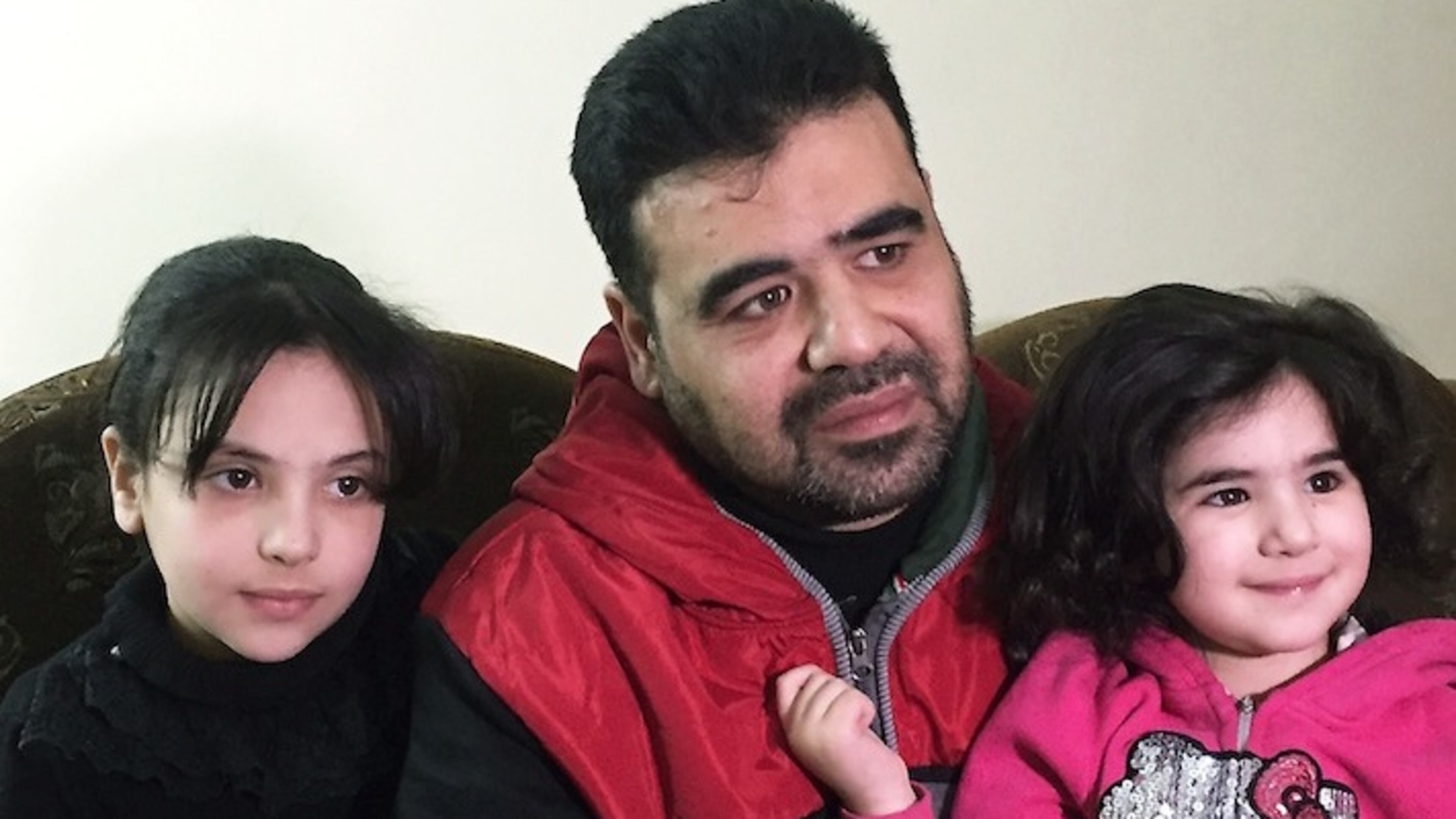 Syrian refugee Mahmoud Mansour, 43, is shown in this photo, taken Monday, March 6, 2017, in Amman, with his daughters Ruba, 9, and Sahar, 3. Mansour, who has been undergoing vetting for resettlement to the U.S. for the past year, says he was devastated by President Donald Trump's travel ban and remains confused about how the revised version could affect his hopes for future in the U.S. (AP Photo/Karin Laub)