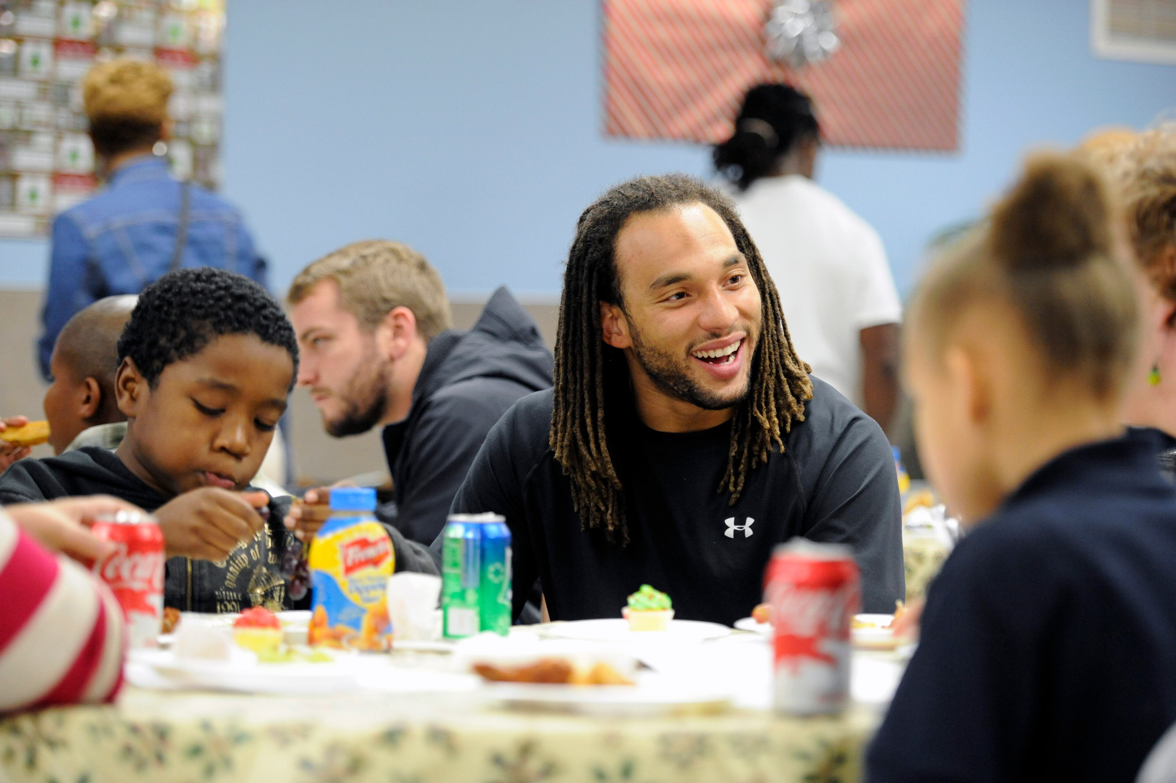 Atlanta Falcons wide receiver Kevin Cone eats with kids before taking them shopping at Wal-Mart Tuesday, Dec. 11, 2012, in Suwanee. He and other Falcons players were participating in the program "Shop with a Jock" in which they provided 37 children from an Atlanta area mission with a $100 gift card and helped them shop.