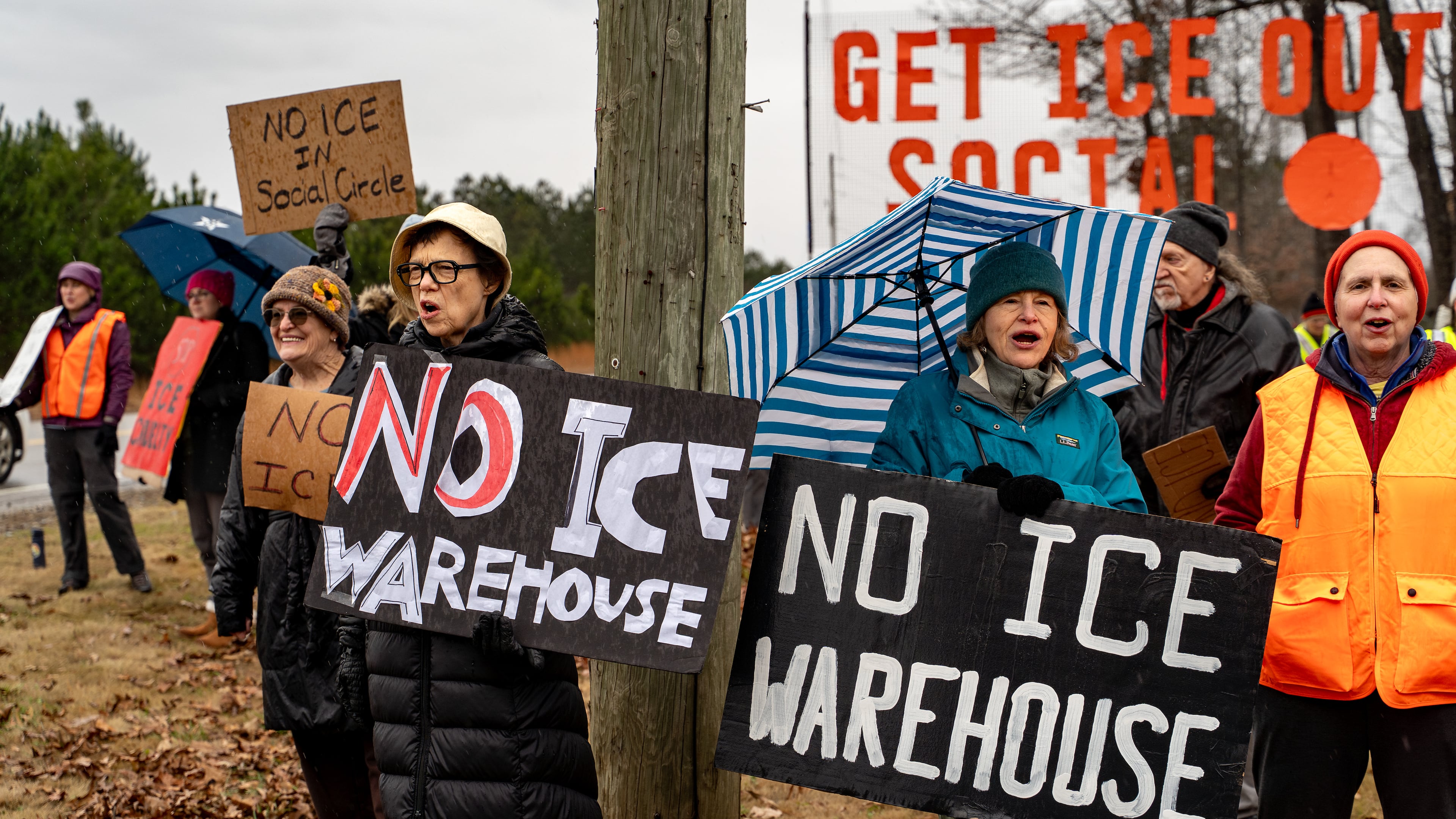 Protesters gather on Social Circle Parkway in the city of Social Circle to voice opposition to the Department of Homeland Security buying and converting a warehouse into an immigrant detention facility on Wednesday, Jan 14, 2026. The city filed a federal lawsuit Wednesday to block the Trump administration from doing so. (Ben Hendren/AJC)