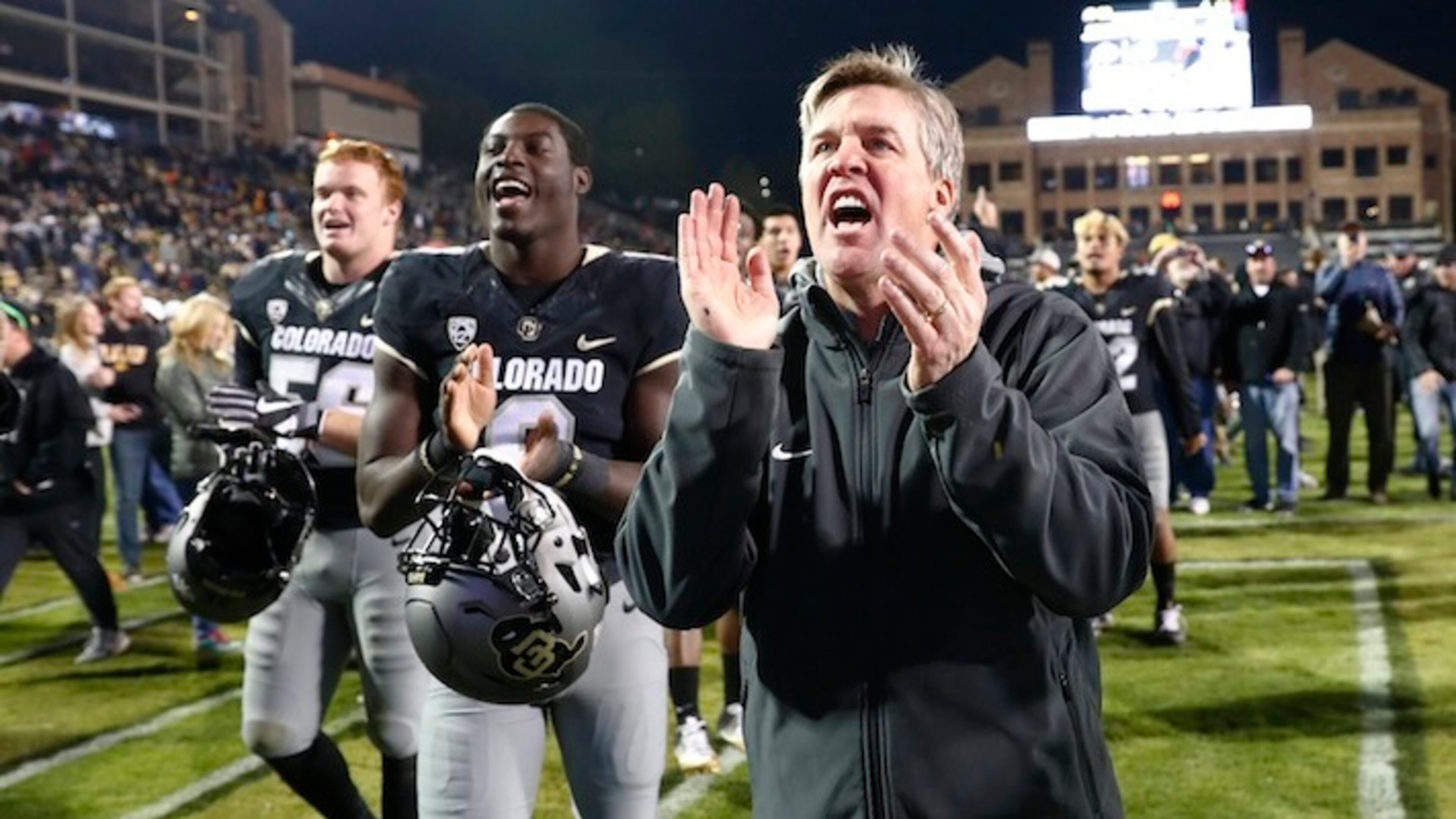 Colorado Buffaloes coach Mike MacIntyre sings the school song with players in the second half of an NCAA college football game Saturday, Nov. 19, 2016, in Boulder, Colo. Colorado won 38-24. (AP Photo/David Zalubowski)