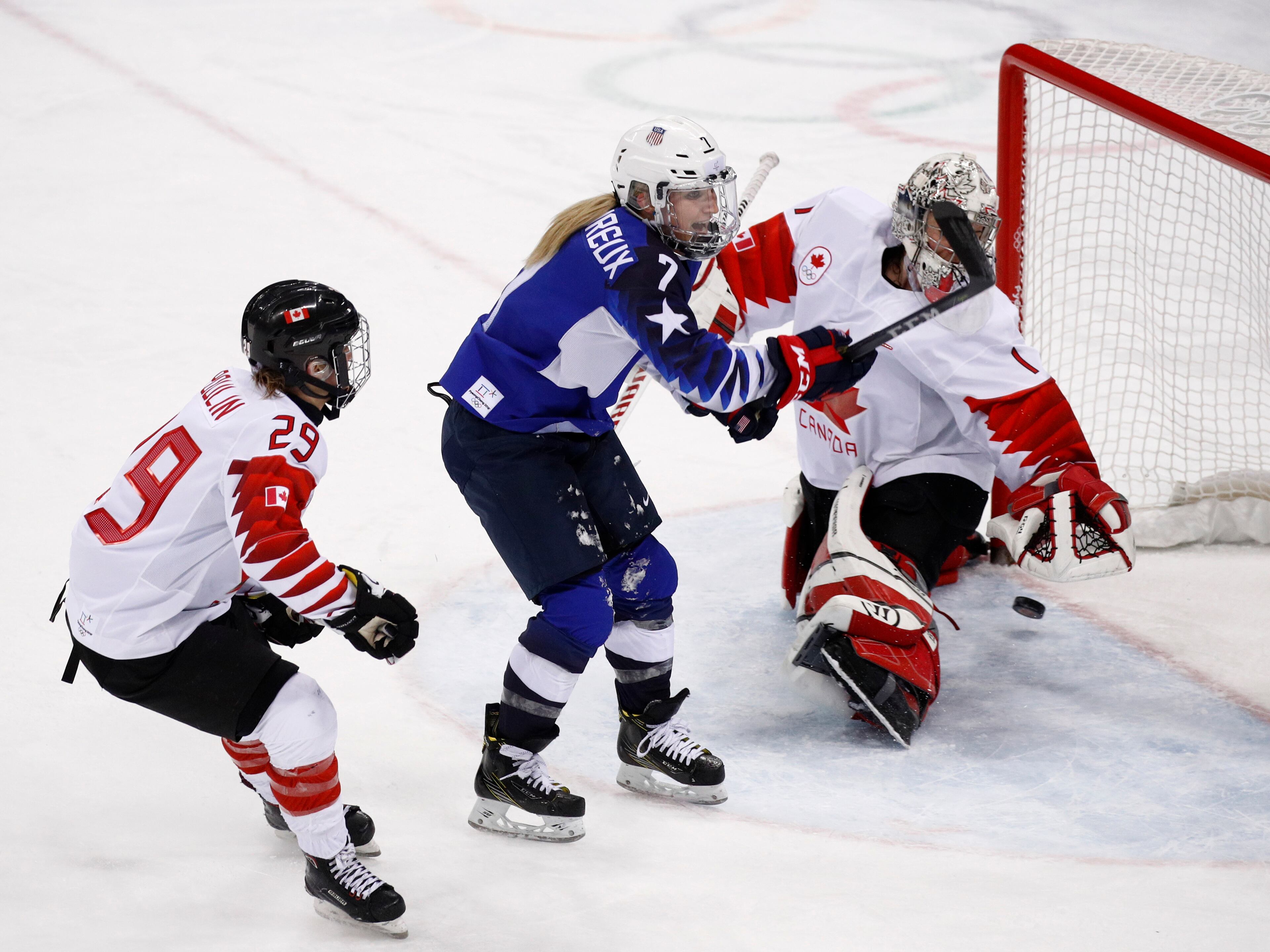 Monique Lamoureux-Morando (7), of the United States, shoot the puck past goalie Shannon Szabados (1), of Canada, for as goal during the third period of the women's gold medal hockey game at the 2018 Winter Olympics in Gangneung, South Korea, Thursday, Feb. 22, 2018. (AP Photo/Jae C. Hong)