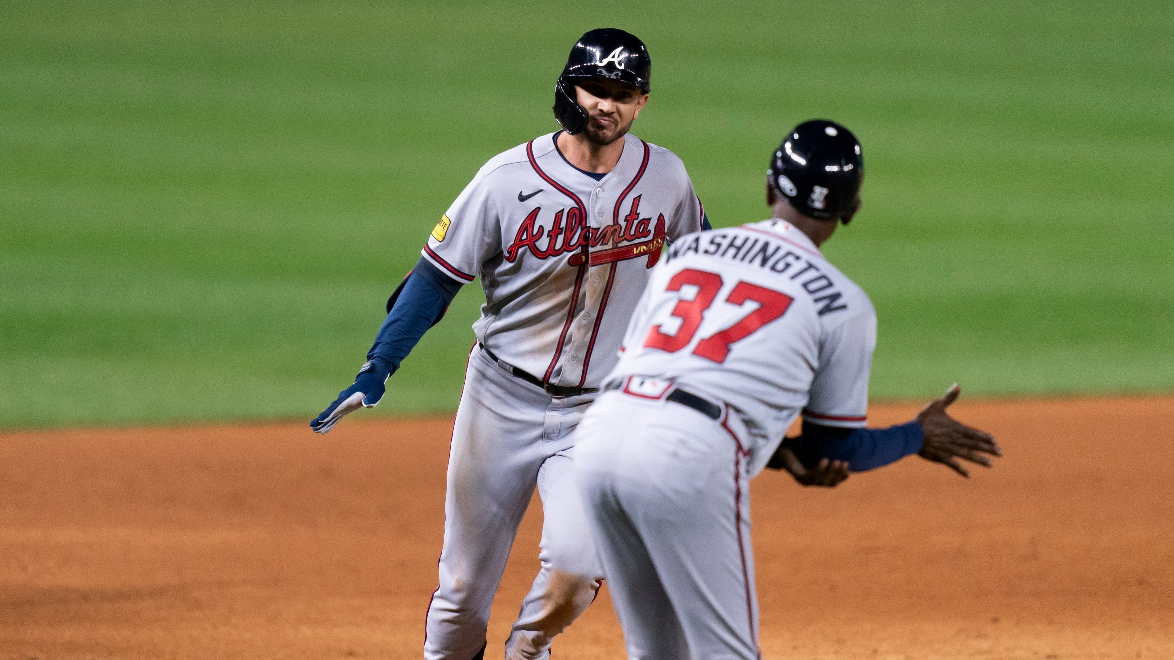 Atlanta Braves' Forrest Wall, left, celebrates with third base coach Ron Washington, right, after hitting a two-run home run during the sixth inning of the second game of a baseball doubleheader against the Washington Nationals, Sunday, Sept. 24, 2023, in Washington. (AP Photo/Stephanie Scarbrough)