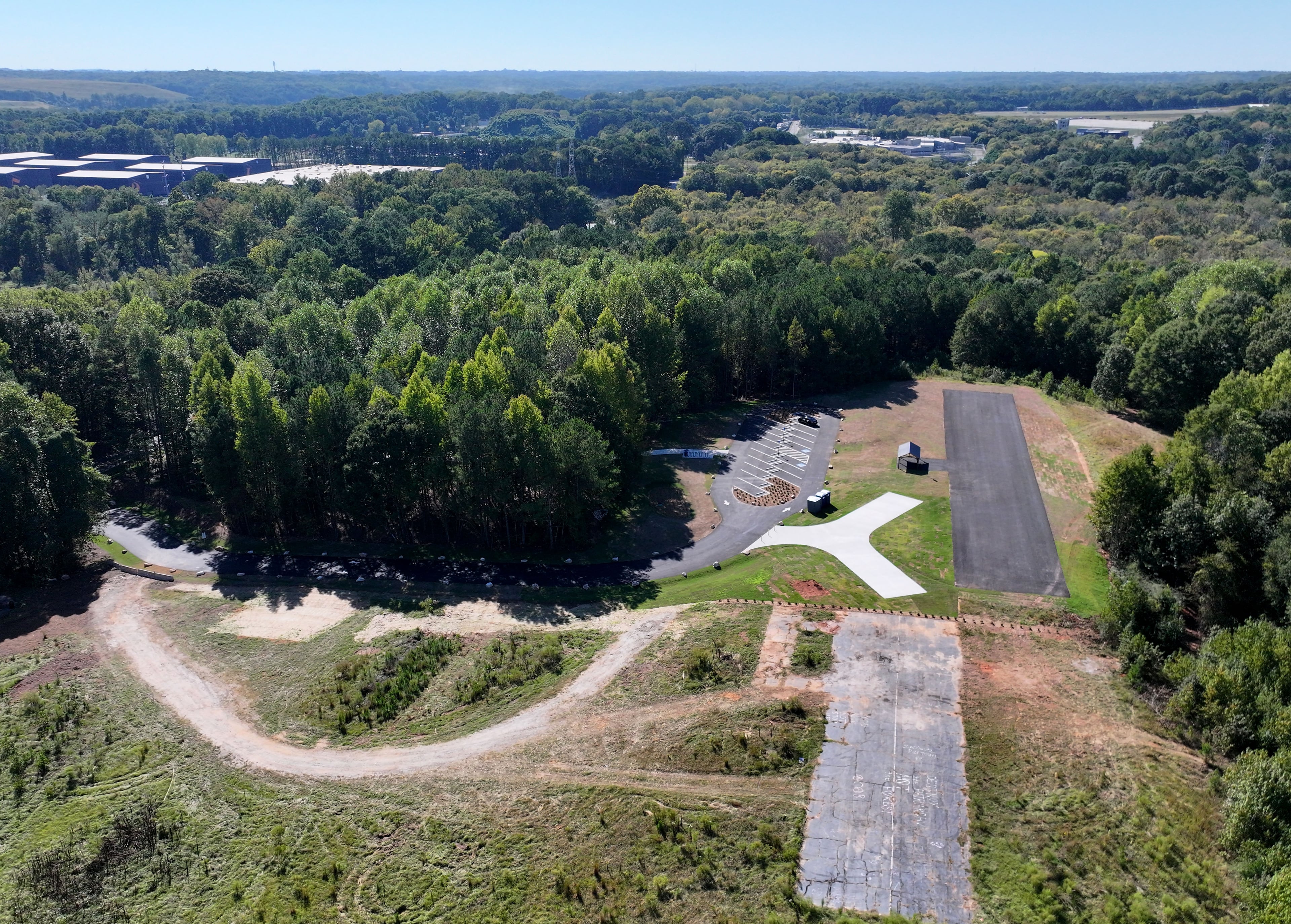 An aerial photo shows Intrenchment Creek at Michelle Obama Park in unincorporated DeKalb County on Tuesday, Sept. 29, 2026. The park project extends access to the 10-mile South River Trail while also preserving the county’s only remote-controlled airplane field. (Hyosub Shin/AJC)