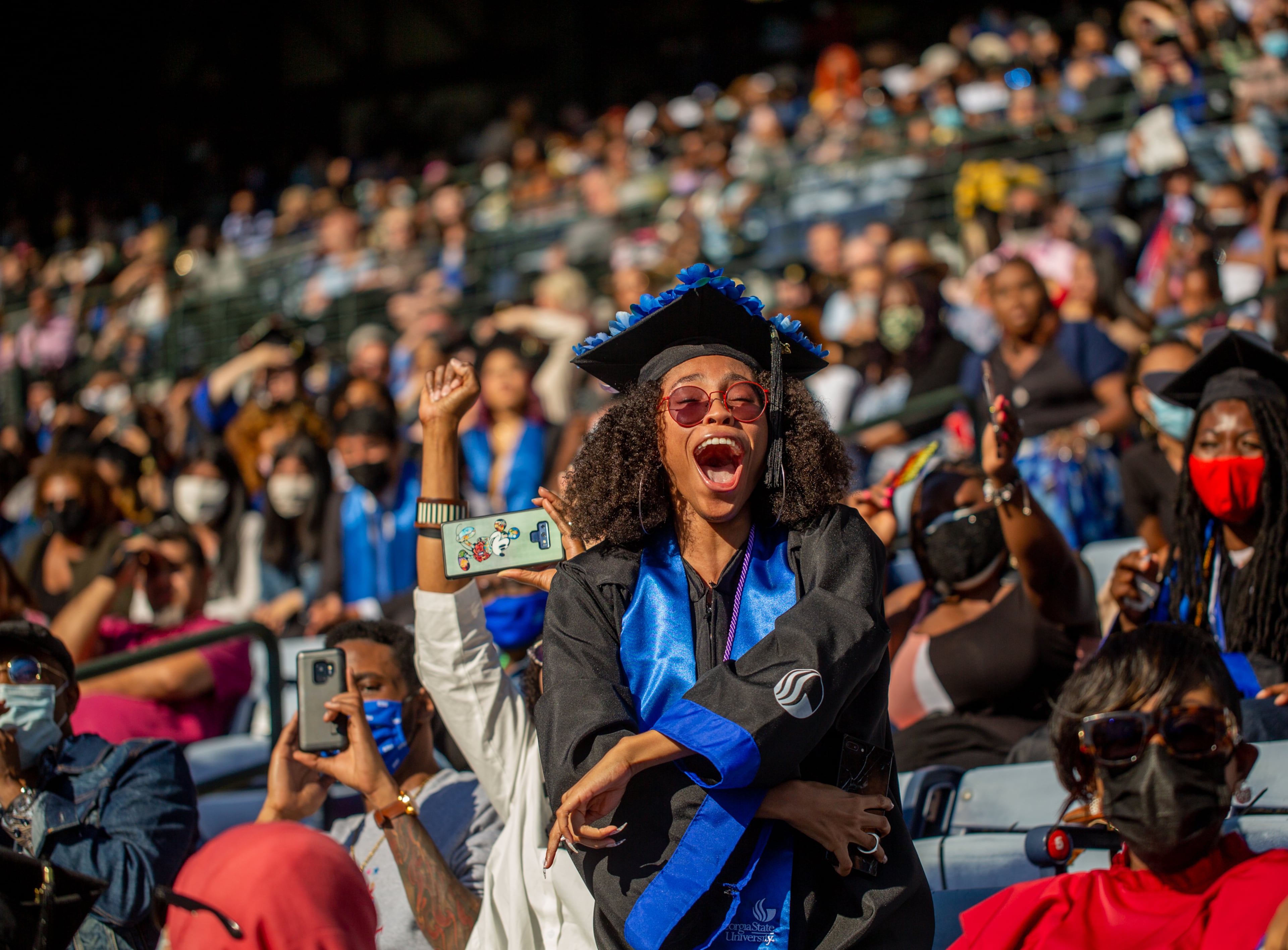 Sydney Henderson celebrates as her name read after earning her education degree from Georgia State University during graduation at Center Parc Stadium on Thursday, May 6, 2021. GSU graduated 5000 students this year. (Jenni Girtman for The Atlanta Journal - Constitution)