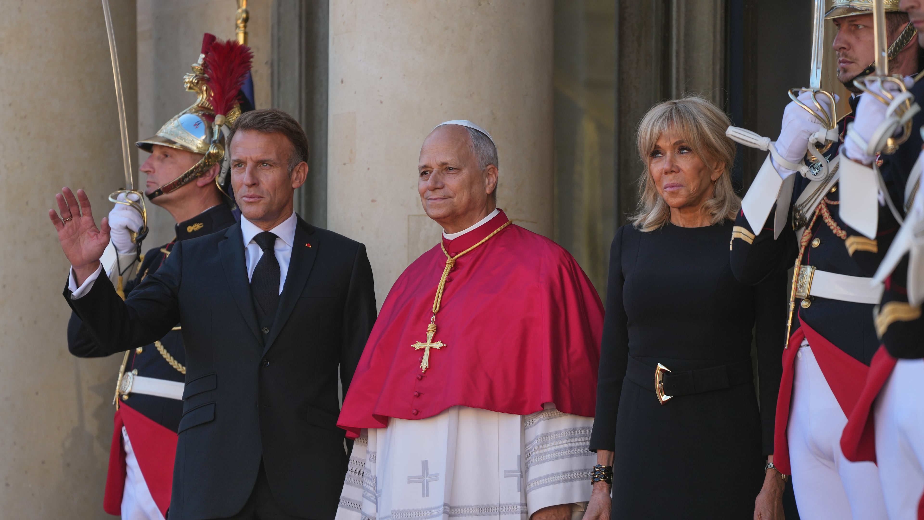 Pope Leo XIV, center, is welcomed by French President Emmanuel Macron, left, and his wife Brigitte as he arrives at the Elysee Palace in Paris, Friday, Sept. 25, 2026. (AP Photo/Gregorio Borgia)