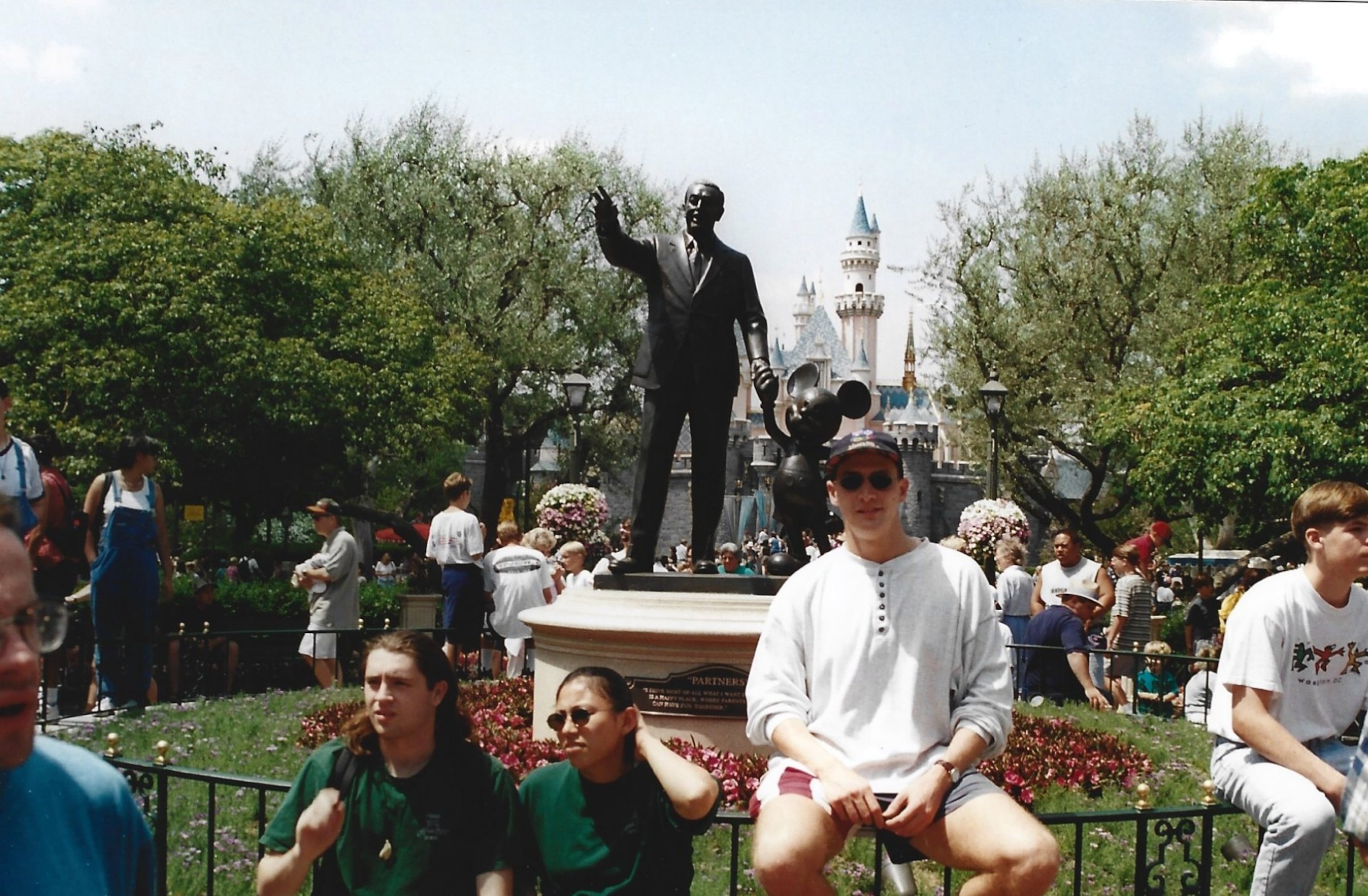 Steve sits in front of a statue of Walt Disney at Disneyland Park in Anaheim, California. (Courtesy of Steve Leo)