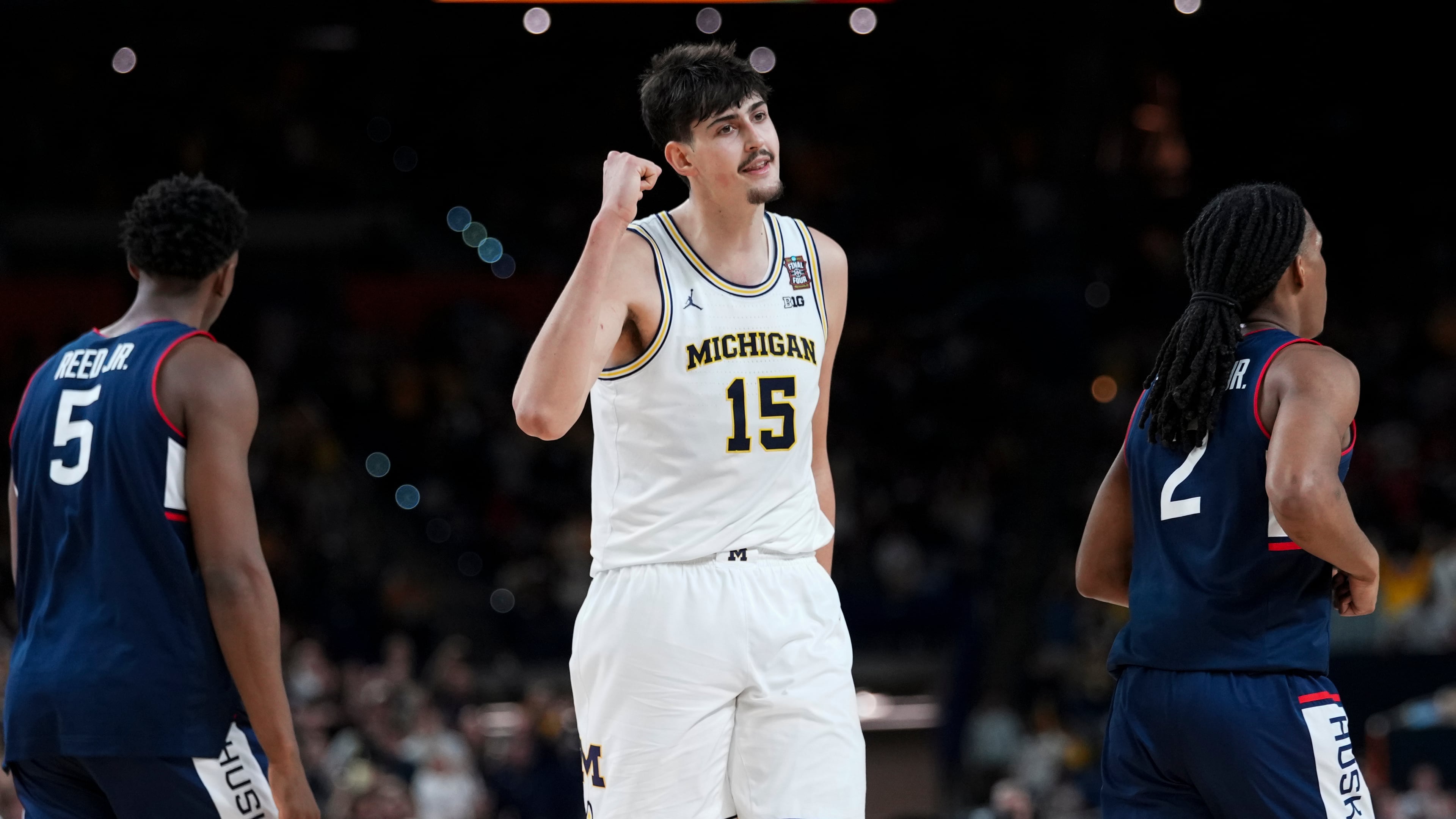 Michigan center Aday Mara — pictured in the national championship game against UConn in April — is 21 years old, 7-foot-3 and 260 pounds, and he has named Big 10 Defensive Player of the Year last season. (Abbie Parr/AP)