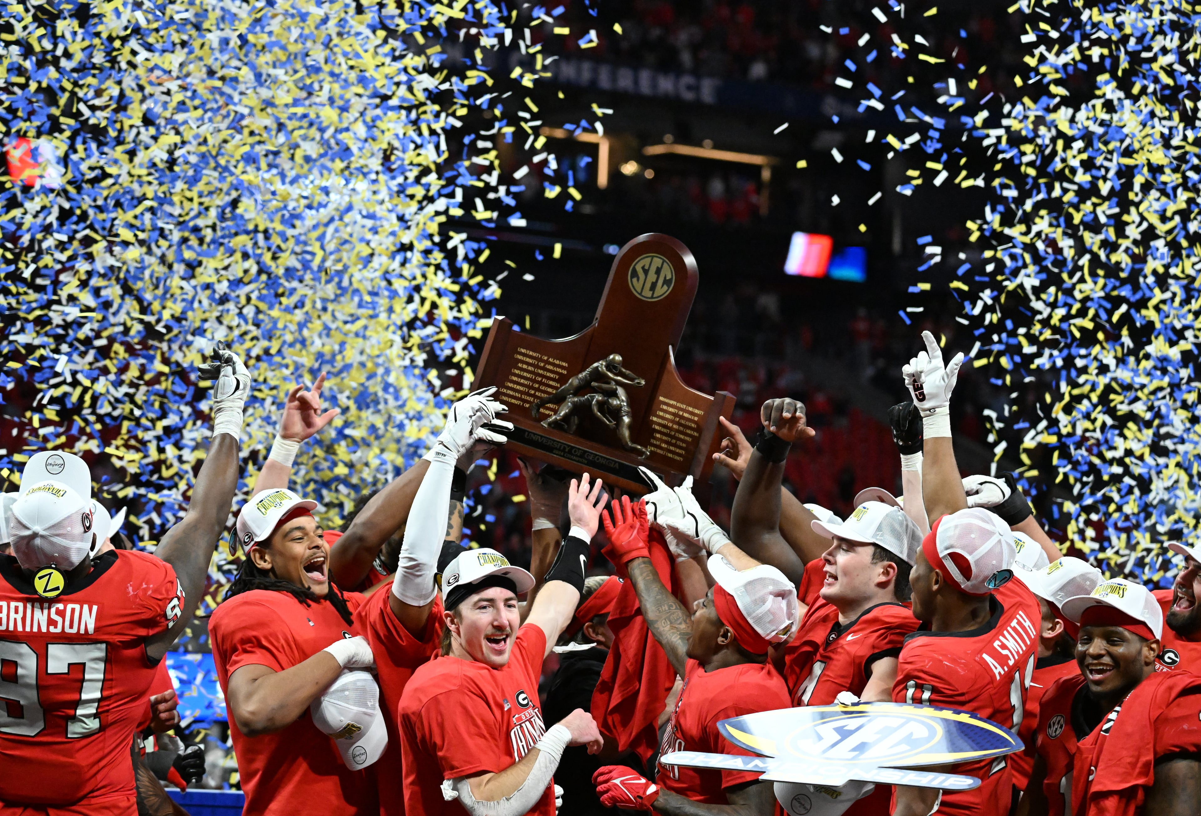 Georgia players celebrate victory over Texas in overtime during the SEC Championship football game at the Mercedes-Benz Stadium, Saturday, December 7, 2024, in Atlanta. Georgia won 22-19 over Texas in overtime. (Hyosub Shin / AJC)