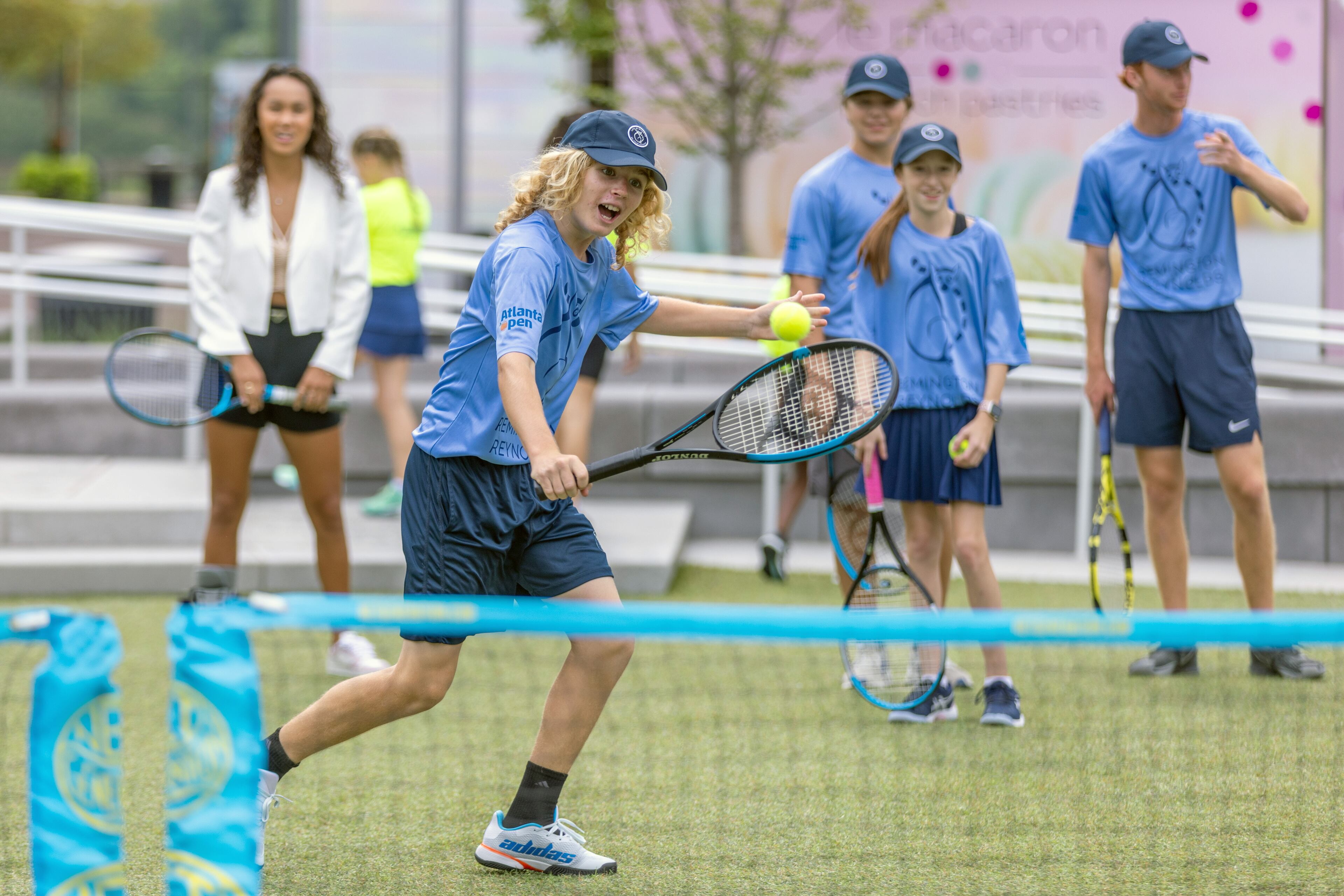 Everett Meinhardt volleys with other Official Ball kids before the start of the Atlanta Open Media Day at Atlantic Station Tuesday, June 28, 2022. (Steve Schaefer / steve.schaefer@ajc.com)