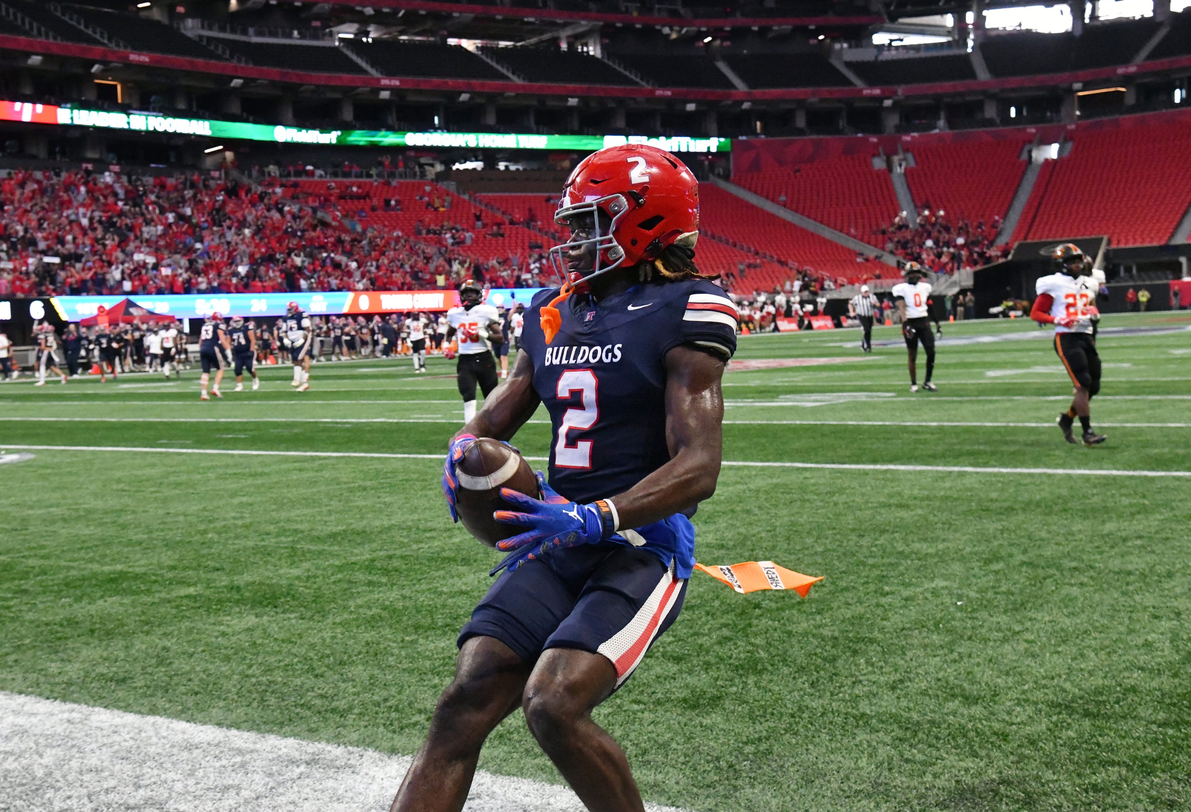 Toombs County's wide receiver Lagonza Hayward (2) scores a touchdown during the first half in GHSA Class A-Division State Championship game at Mercedes-Benz Stadium, Tuesday, December 17, 2024, in Atlanta. (Hyosub Shin / AJC)