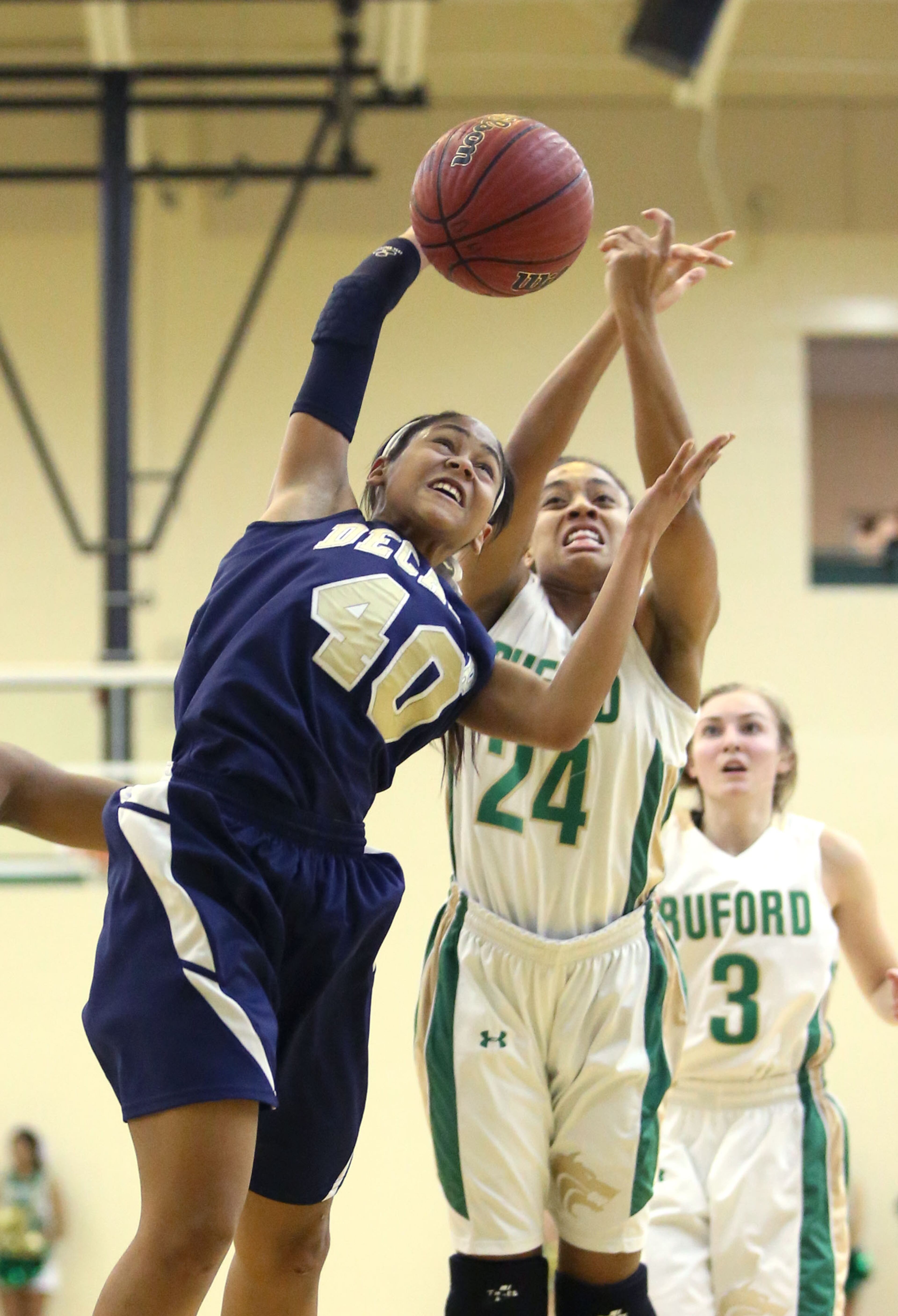 Decatur's Kori Anderson (40) and Buford's Ashley Kroeger (24) fight for a rebound. Buford defeated Decatur 41-28 in the second round of the Class AAA state basketball tournament. JASON GETZ / SPECIAL