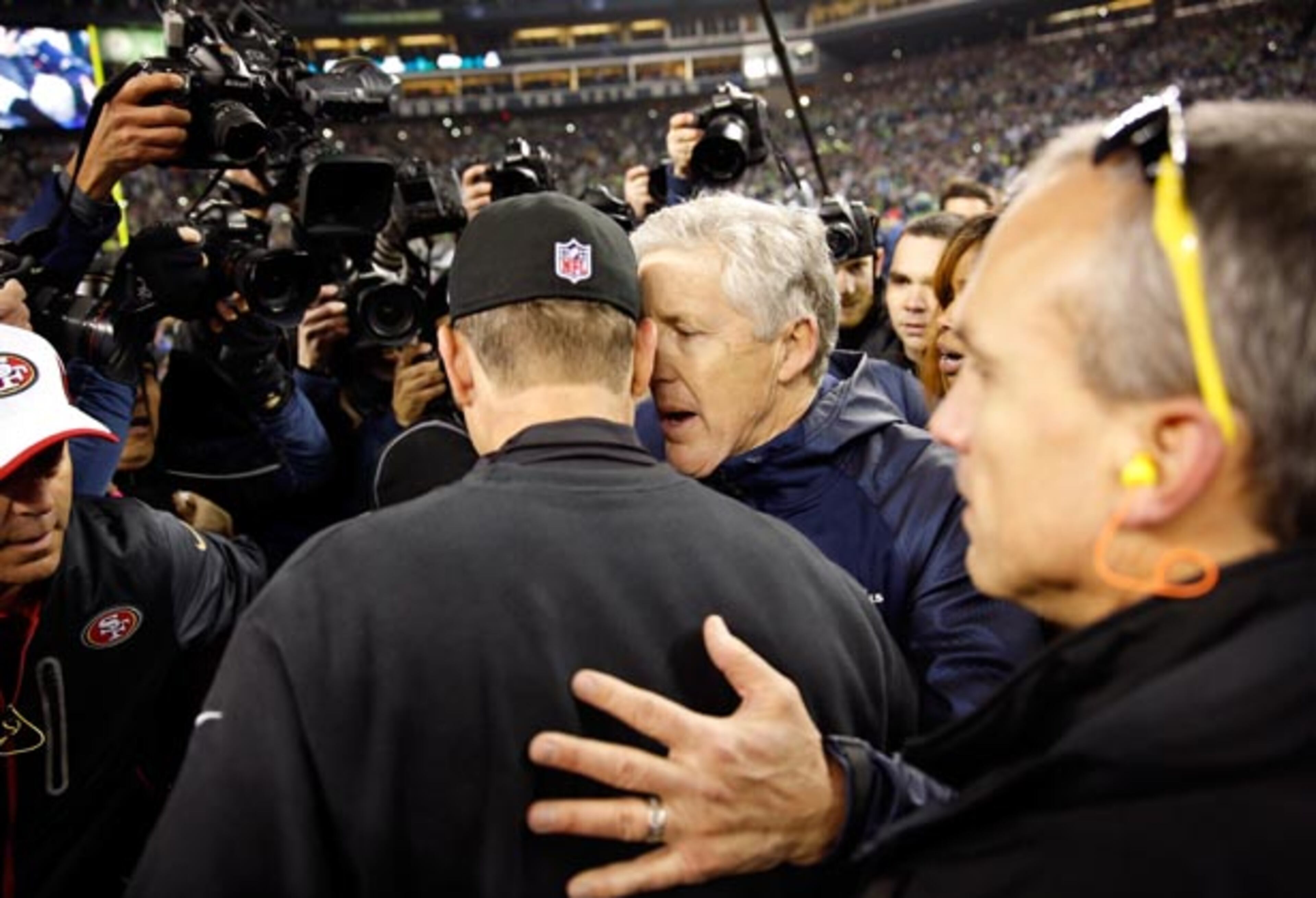 SEATTLE, WA - JANUARY 19: Head coach Pete Carroll of the Seattle Seahawks and head coach Jim Harbaugh of the San Francisco 49ers shake hands after the Seahawks 23-17 victory during the 2014 NFC Championship at CenturyLink Field on January 19, 2014 in Seattle, Washington. (Photo by Otto Greule Jr/Getty Images)