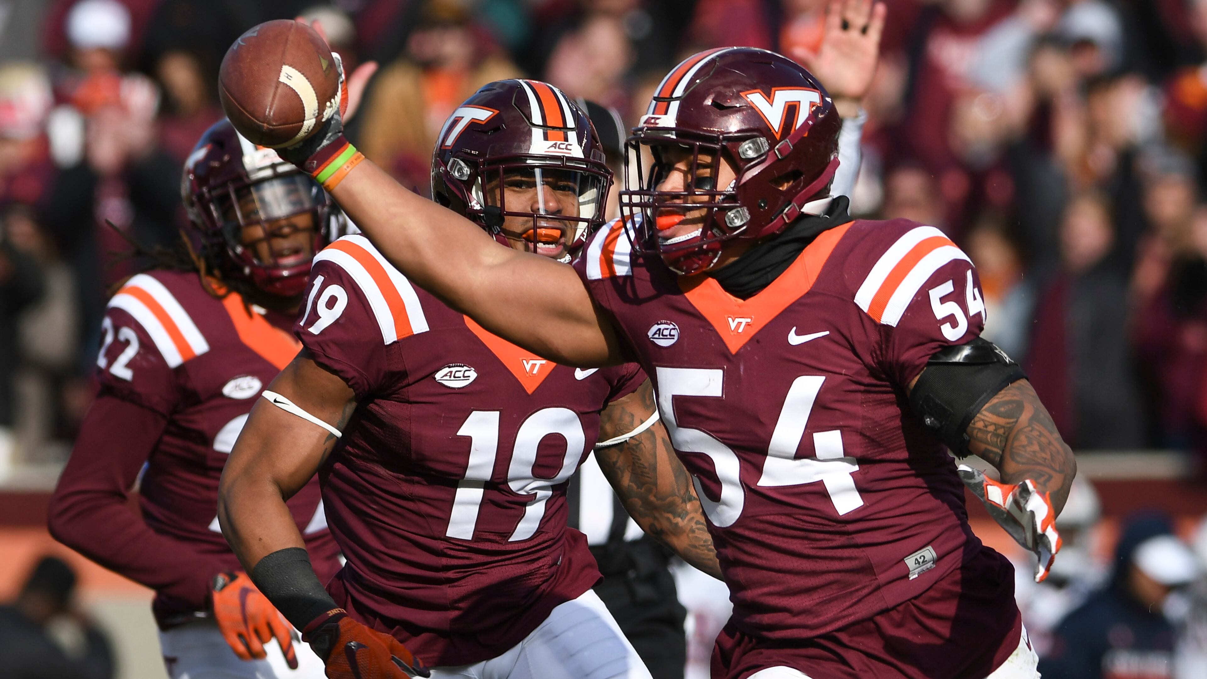 BLACKSBURG, VA - NOVEMBER 26: Linebacker Andrew Motuapuaka #54 of the Virginia Tech Hokies celebrates his interception against the Virginia Cavaliers with defensive back Chuck Clark #19 in the second half at Lane Stadium on November 26, 2016 in Blacksburg, Virginia. Virginia Tech defeated Virginia 52-10. (Photo by Michael Shroyer/Getty Images)