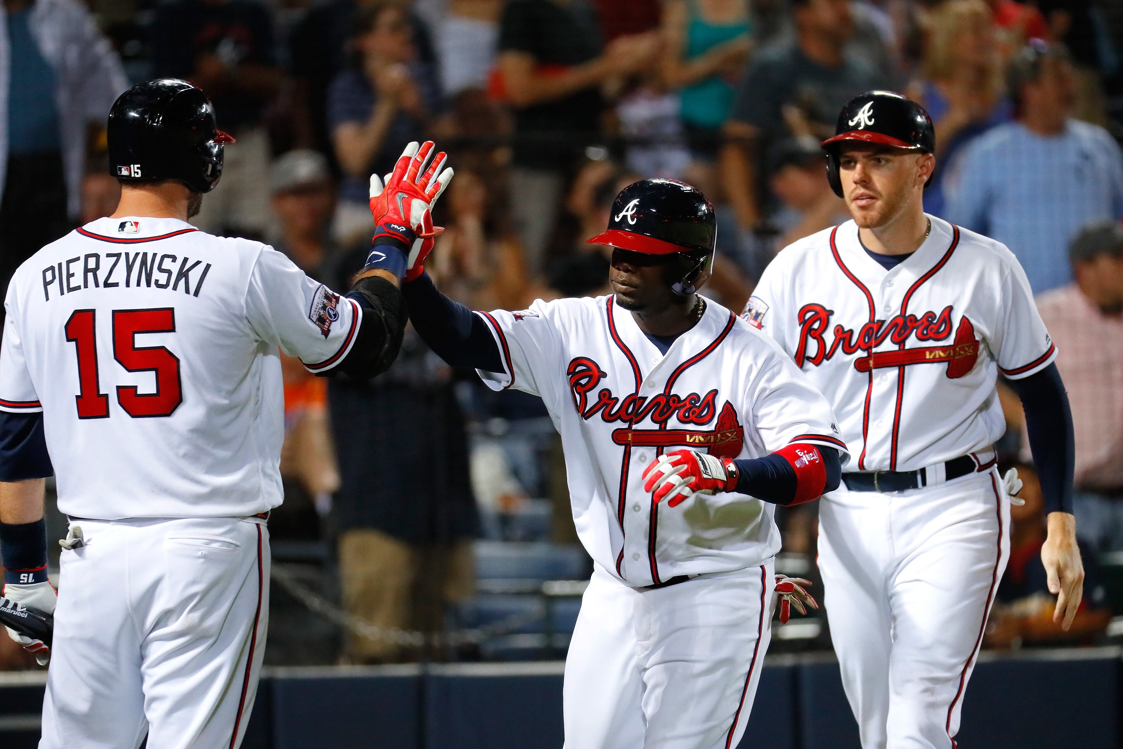 ATLANTA, GA - JUNE 23: Adonis Garcia #13 of the Atlanta Braves reacts with A.J. Pierzynski #15 after hitting a two-run homer to score Freddie Freeman #5 in the eighth inning against the New York Mets at Turner Field on June 23, 2016 in Atlanta, Georgia. (Photo by Kevin C. Cox/Getty Images)