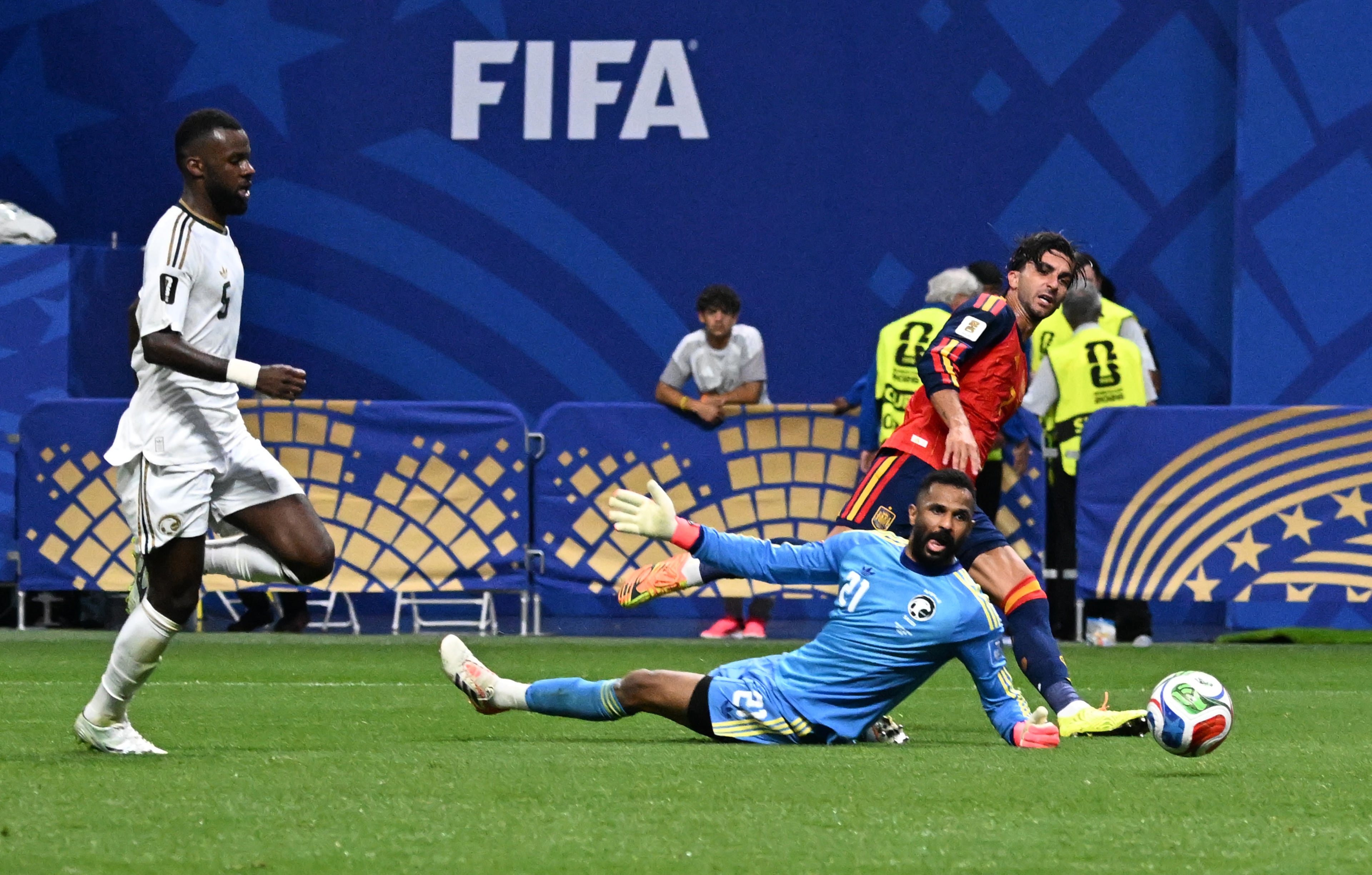 Spain's Ferran Torres (top right) is unable to score past Saudi Arabia goalkeeper Mohammed Al-Owais (center) as Hassan Al-Tambakti gives chase during the second half of the Spain vs. Saudi Arabia World Cup match Sunday, June 21, 2026, at Atlanta Stadium. (Hyosub Shin/AJC)