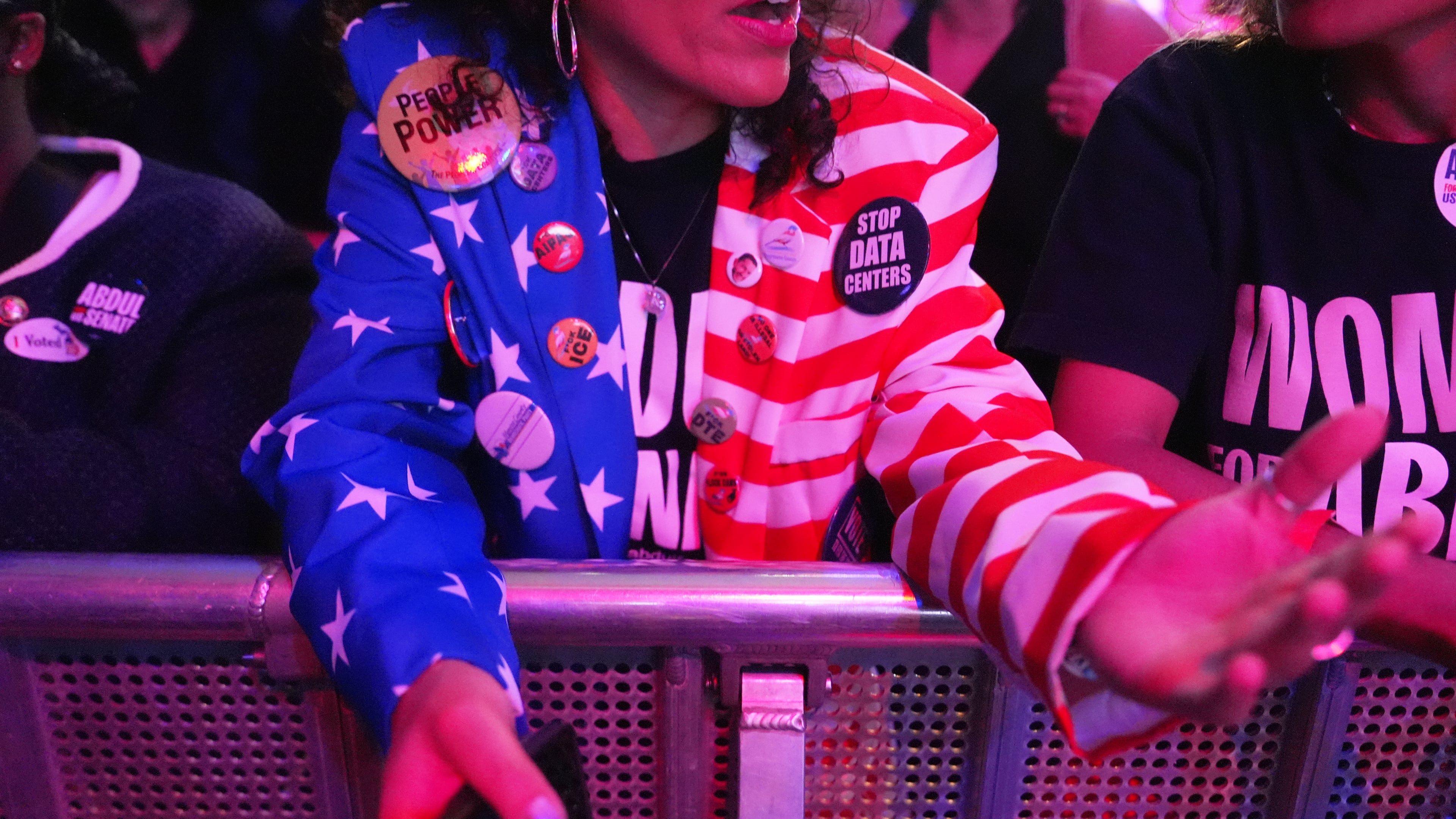 An attendee wears a pin reading "STOP DATA CENTERS" during a primary election night event for Abdul El-Sayed, a progressive candidate in the Democratic primary for U.S. Senate in Michigan, Tuesday, Aug. 4, 2026, at the Majestic Theatre in Detroit. (AP Photo/Julia Demaree Nikhinson)