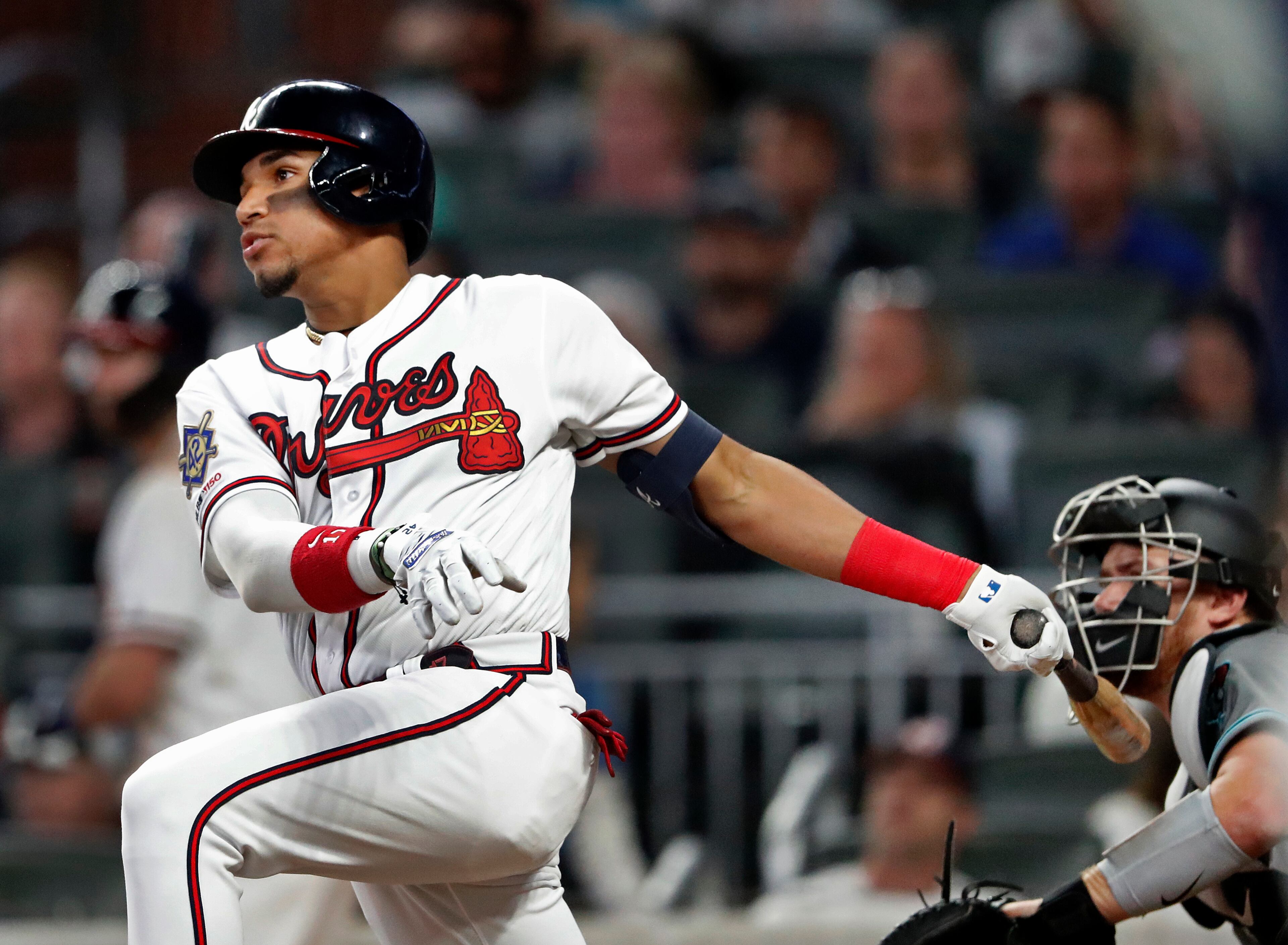 Atlanta Braves' Johan Camargo follows through on a three-run double in the fifth inning of a baseball game against the Arizona Diamondbacks, Tuesday, April 16, 2019, in Atlanta. (AP Photo/John Bazemore)