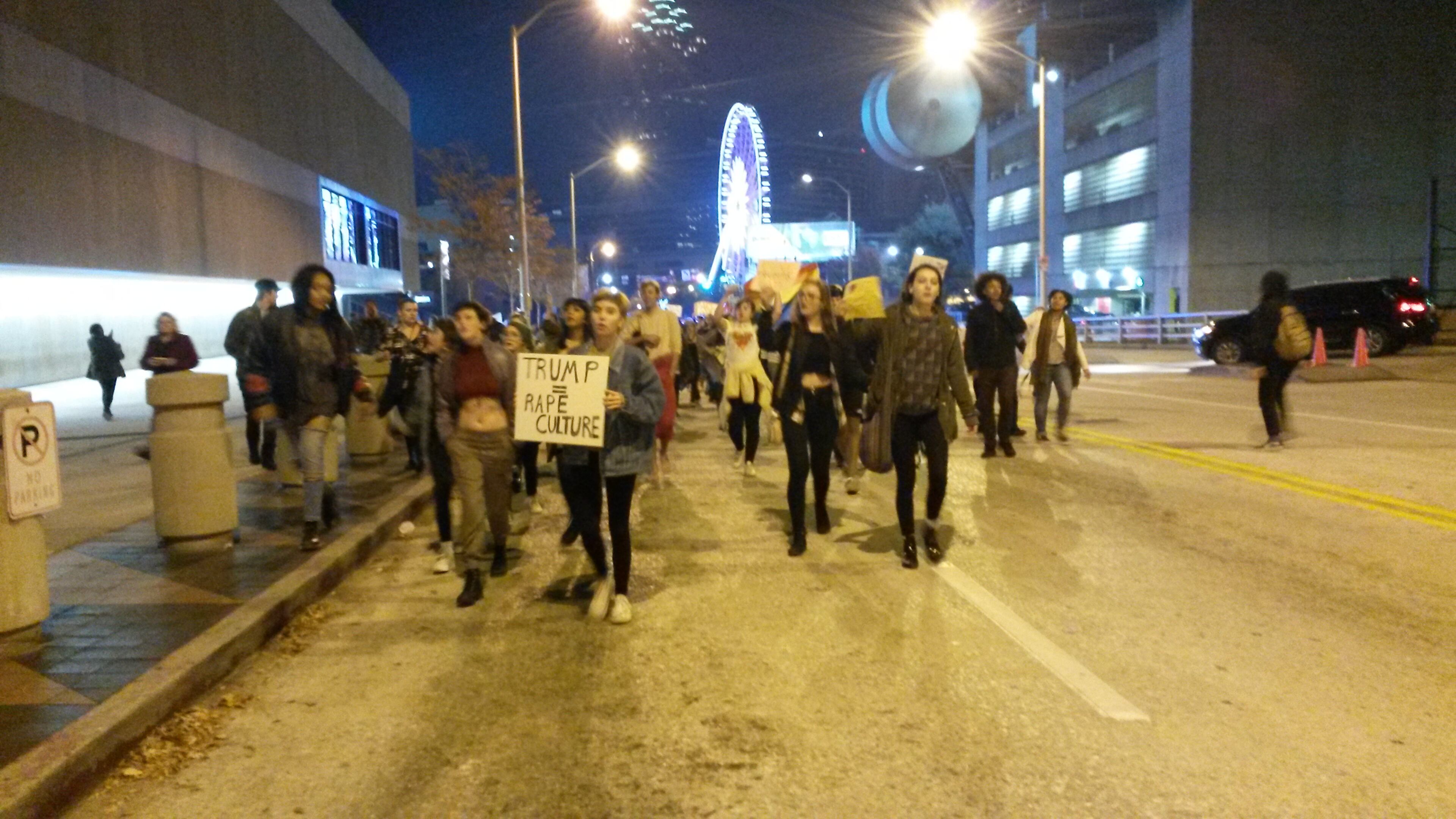 Protesters march by CNN Center Wednesday night. They took to the streets in downtown Atlanta to protest the election of Donald Trump. MATT KEMPNER/MKEMPNER@AJC.COM