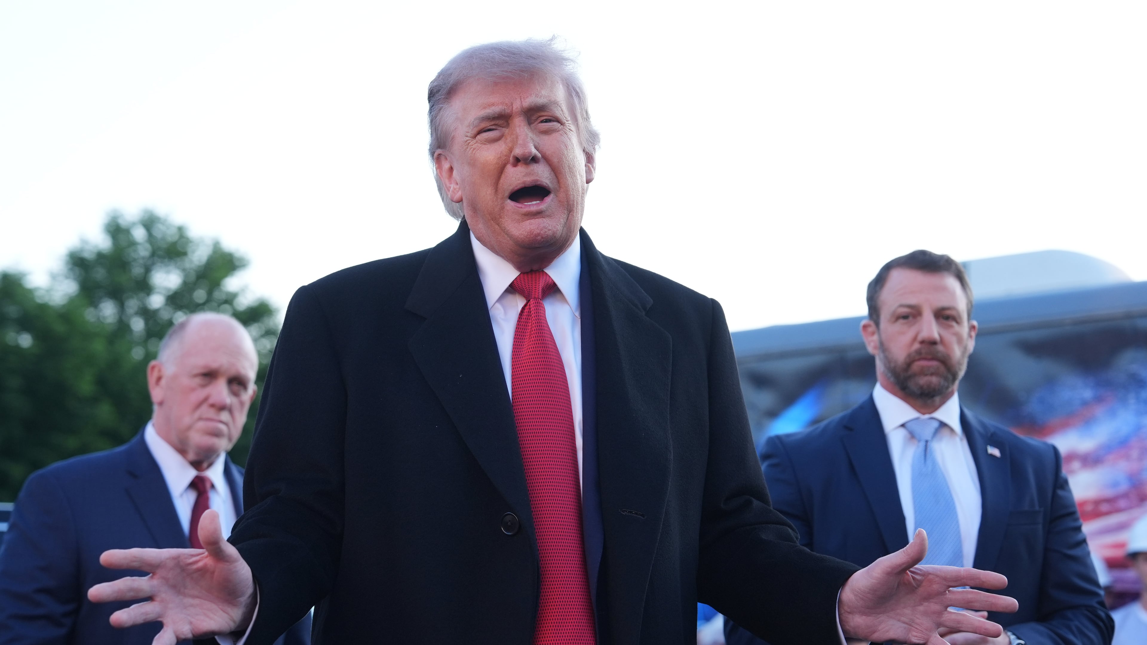 President Donald Trump speaks as he visits the Lincoln Memorial Reflecting Pool to see the new blue protective coating being applied as part of a renovation project, Thursday, May 7, 2026, in Washington, as White House boarder czar Tom Homan and Homeland Security Secretary Markwayne Mullin listen. (AP Photo/Mark Schiefelbein)
